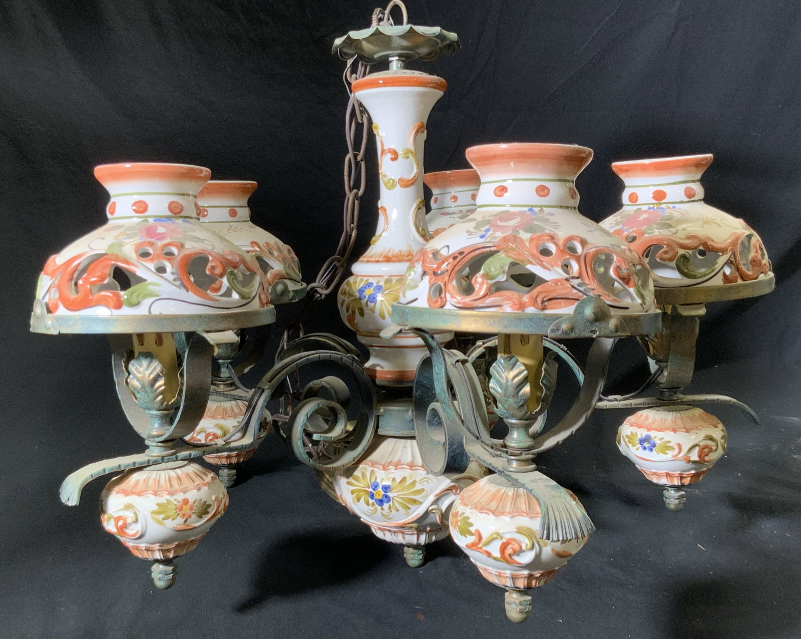 Vintage Hand Painted Ceramic & Bronze Chandelier: Vintage hand painted ceramic and metal, possibly bronze, chandelier. Curled metalwork and pierced ceramic designs throughout. Florals and foliage motifs to the ceramics. Measures approx. 44H x 20W in.