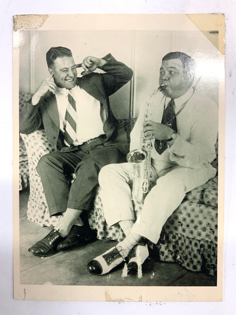 FLASHCARDS GEHRIG FIND RUTHS OFF PITCH Card: Backside reads FLASHCARDS GEHRIG FINDS RUTH OFF PITCH. Card depicts Babe Ruth & Lou Gehrig seated Ruth playing a saxophone Gehrig covering his ears. PIece is vintage. Measures approximately 6 inches t