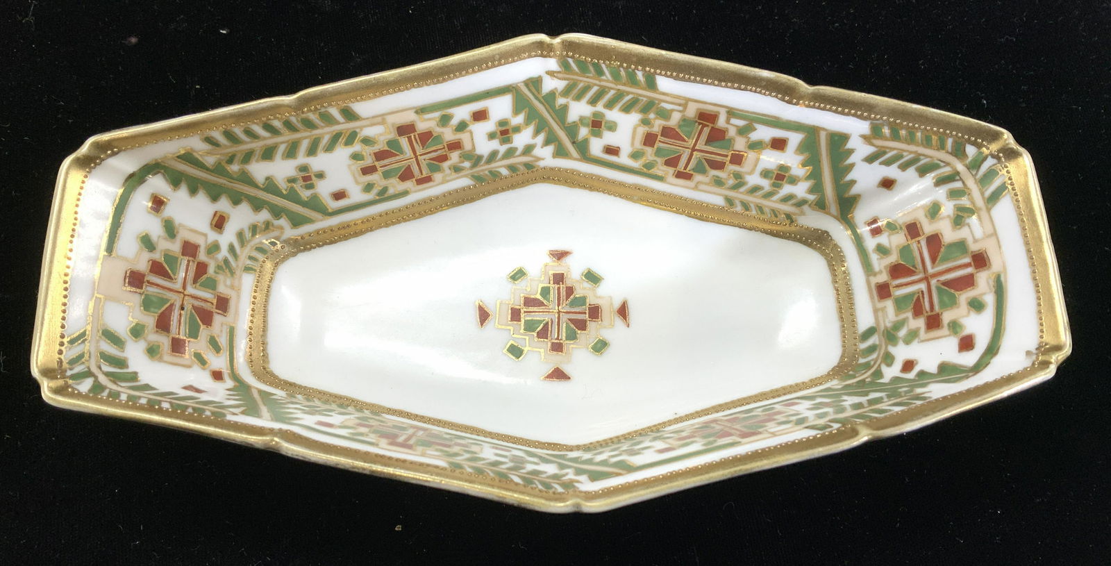 Nippon Hand Painted Porcelain Bowl: White porcelain bowl with abstract shape, hand painted in gilt, red and green. Signed Nippon. Measures 7.75 x 4 x 2 in. Property of Manhattan New York City Americana, Macys, & Milk Bottle collectors e