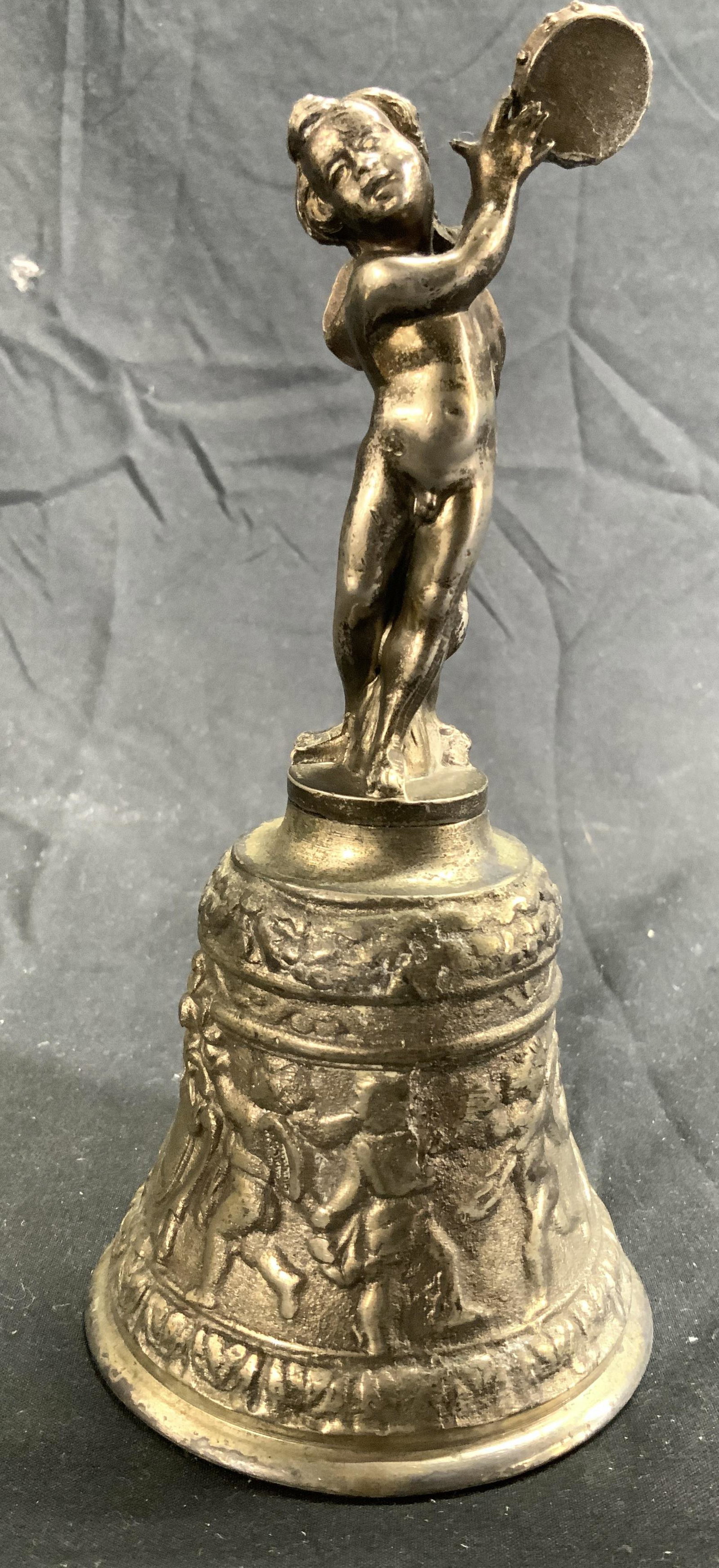 Vintage Pewter Bell W Cherub Figure: Bell is pewter. Piece is vintage possibly antique. Piece has cherub figure at top holding instrument and multiple cherub figures in relief. Measures approx 6.5 inches tall 3 inches wide. Bell, cherub 