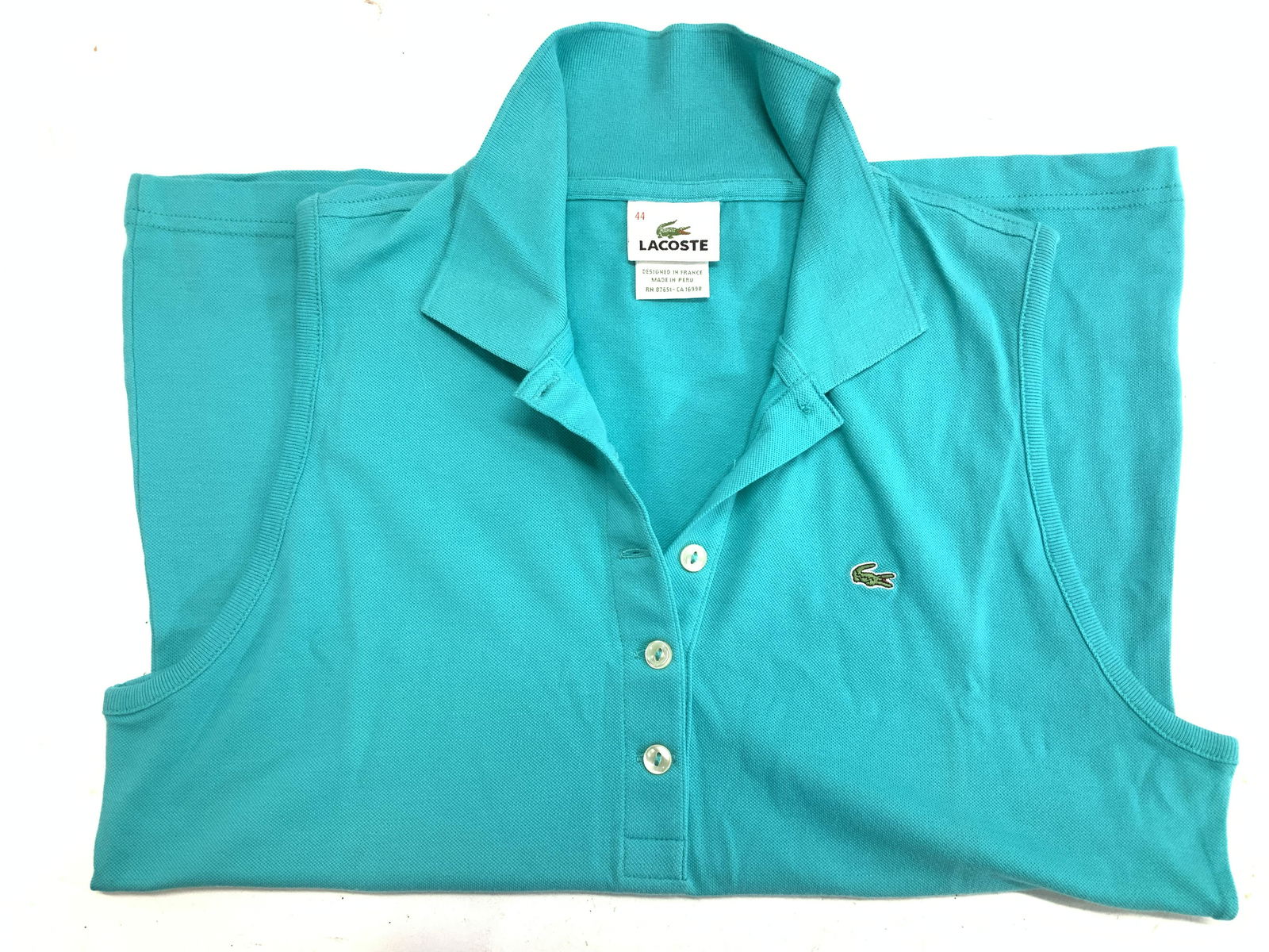 LACOSTE Sleeveless Cotton Golf Polo, France: Turquoise LACOSTE sleeveless shirt, designed in France, 96% cotton, 4% elastane. Ladies size 44. Lacoste Sleeveless Golf Polo, Ladies summer sportswear, Ladies Beach Polo, Lacoste Resort Wear Top, Lad