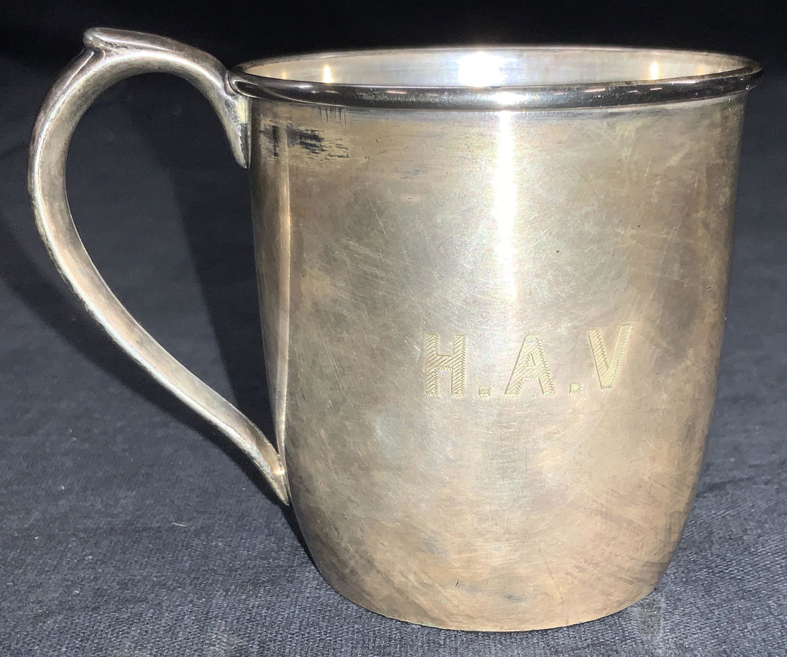 EVANS Silver Plate Vintage Toddler Cup W Bag: Marked Evans EPNS Silver plate toddler cup with side handle. Engraved on side H.A.V. Approximately 2.5 inches tall. Comes with muted pink toned Steuben glass dust bag. Evident surface wearing to cup a