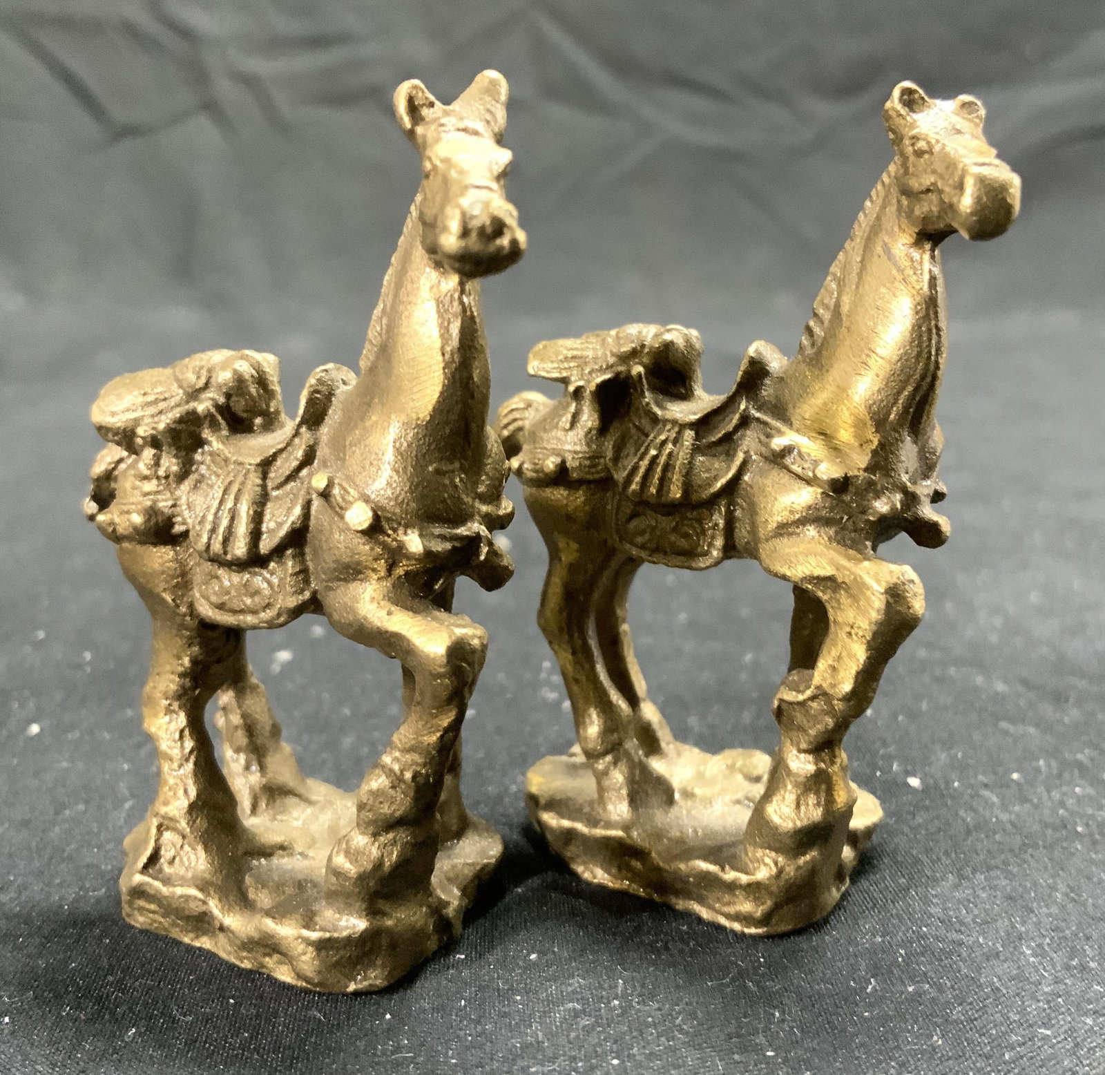 Pair Vintage Brass Horse Figurals: Each figural appears to be brass, possibly gilt bronze. Each figural depicts horse with one hoof raised. Each Piece measures approx 2.5 inches tall 2 inches deep 1 inch wide. Horse Figurals, brass hor