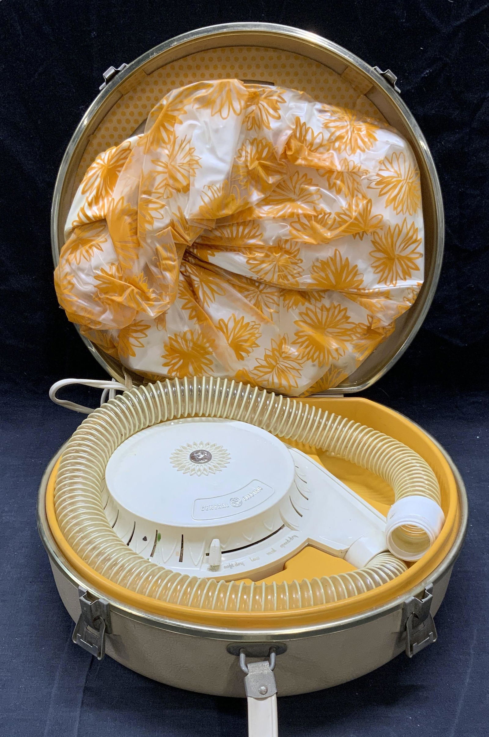 Vintage GENERAL ELECTRIC Retro Hair Dryer: Vintage circa 1950s-60s General Electric hair dryer in beige and orange. Surface wear consistent with exposure. Not tested for function. As Is. Case measures approx. 13.5 x 11.5 x 5 inches. Includes d
