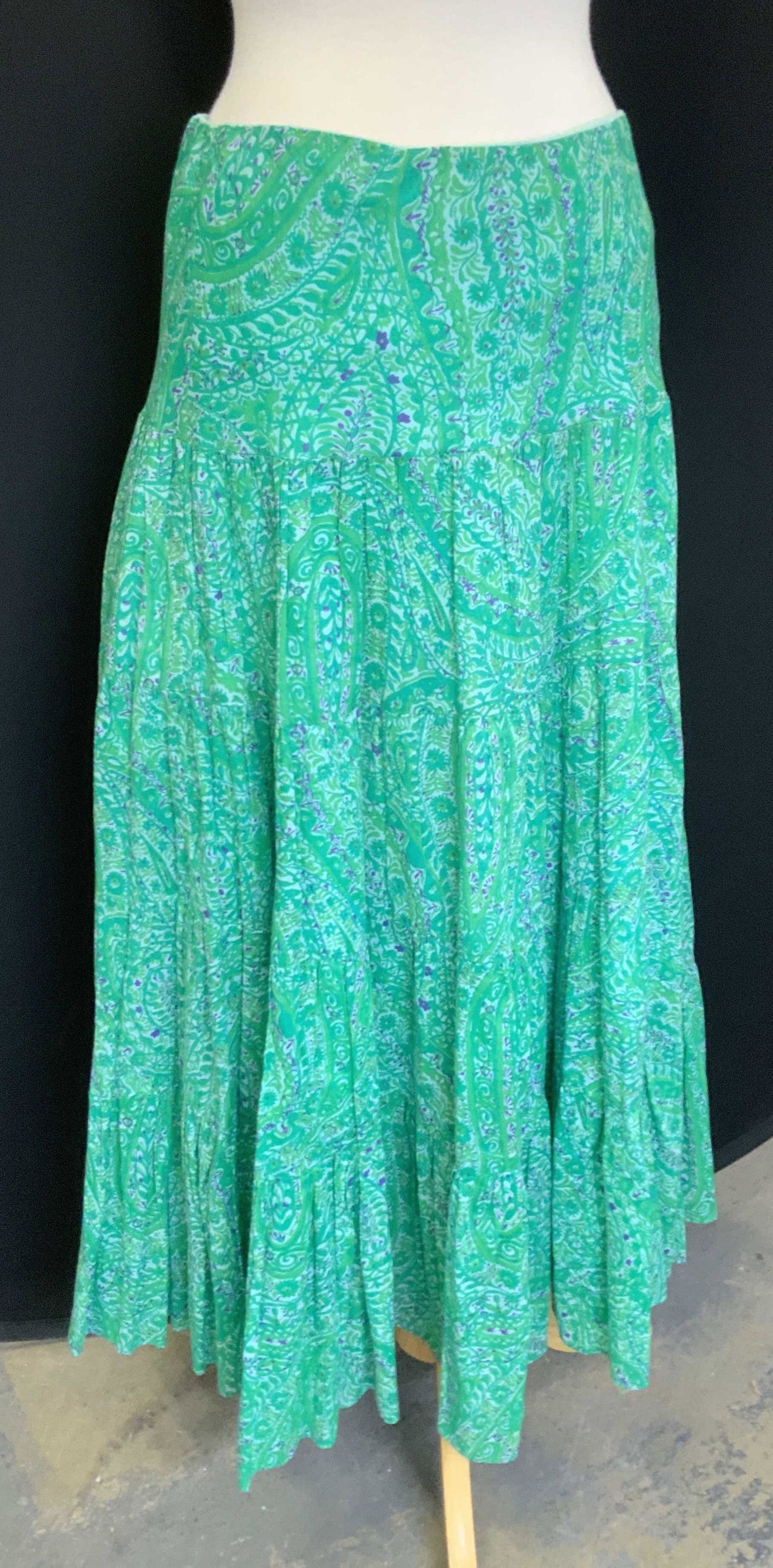 LAUREN Ralph Lauren Long Green Cotton Print Skirt: Ankle length Cotton Skirt with stretch waist and lightly pleated body.Beautiful Indian style print in hues of green and purple. Size Med. 37 in. L Skirt, casual wear, luxury designer Lauren Ralph Laur