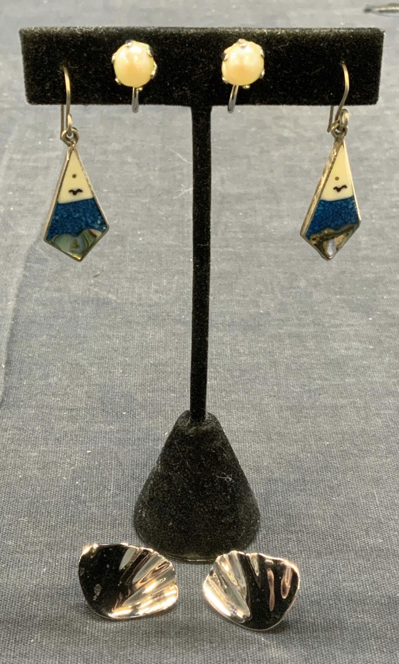 Lot 3 Trifari, Marvella, & Alpaca Earrings: Lot of 3 costume earrings. 1 pair silver tone Trifari earrings. Trademarked to underside. Measure approx. .75 x 5/8 inches. 1 pair Marvella faux pearl earrings with 12k gold filled backing. Trademarke