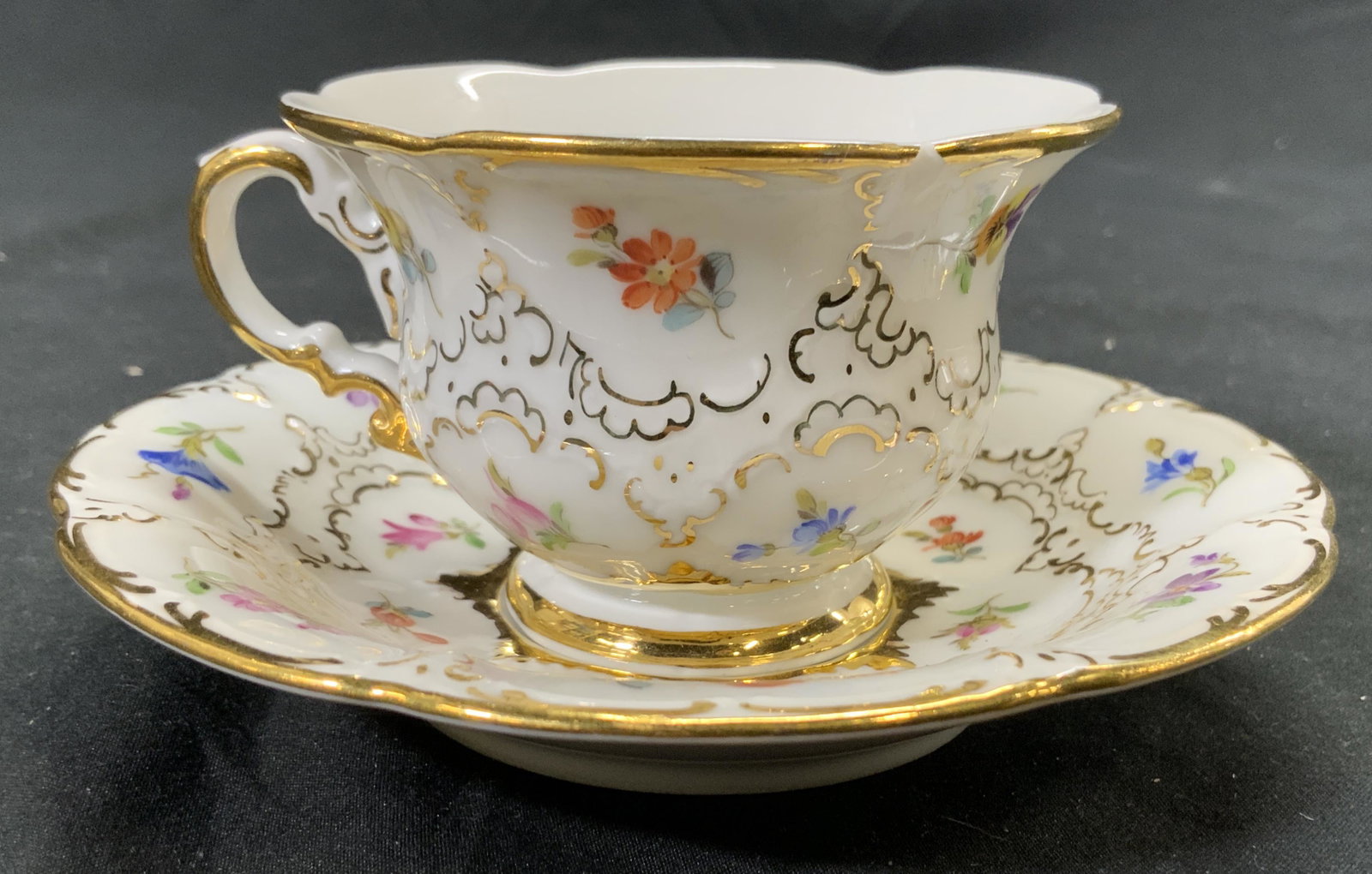 MEISSEN Porcelain Teacup & Saucer: Undersides of each piece have MEISSEN Crossed sword Trademark. Each piece has hand painted, floral, leaf & gilt detail. Saucer measures approx 5 inches diameter. Meissen, decorative arts, Meissen porc