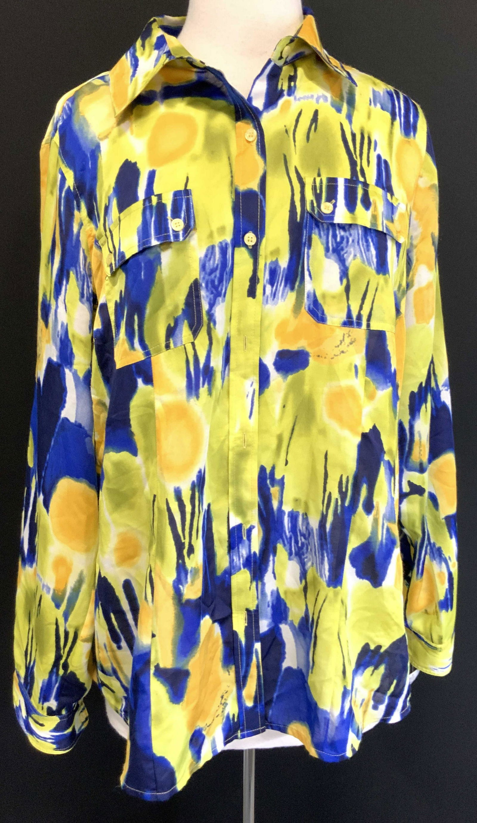 Calvin Klein Tie Die Style Button Up Blouse: Marked on Tags Calvin Klein, 100% Polyester.size OX Long sleeves, collar and front breast pockets. Blouse is the die style streaks of colors such as blue, orange and green throughout. Minor pilling. C