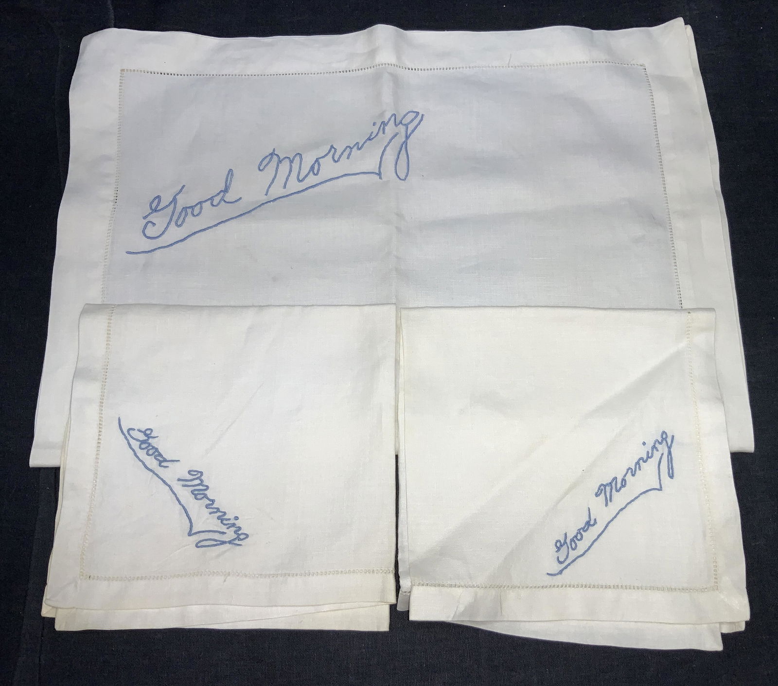 Set 3 Embroidered Tea Towels & Linens: Set of 3 of white tea towel and 2 handkerchiefs with blue embroidery that reads Good Morning. Tea towel is approximately 19 x 13.5 inches, handkerchiefs are approx 11.75 x 12 inches. Evident blemishes