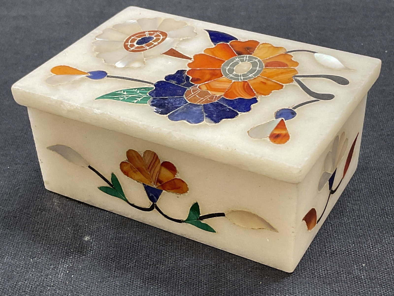 Inlaid Box W Carnelian, Lapis & Mother of Pearl: Inlaid Trinket Box W Carnelian, Lapiz & Mother of Pearl. Measures approx 3 x 2 inches. Floral detail with natural stone. Tested positive for natural stone, some surface wear consistent with age. Weari