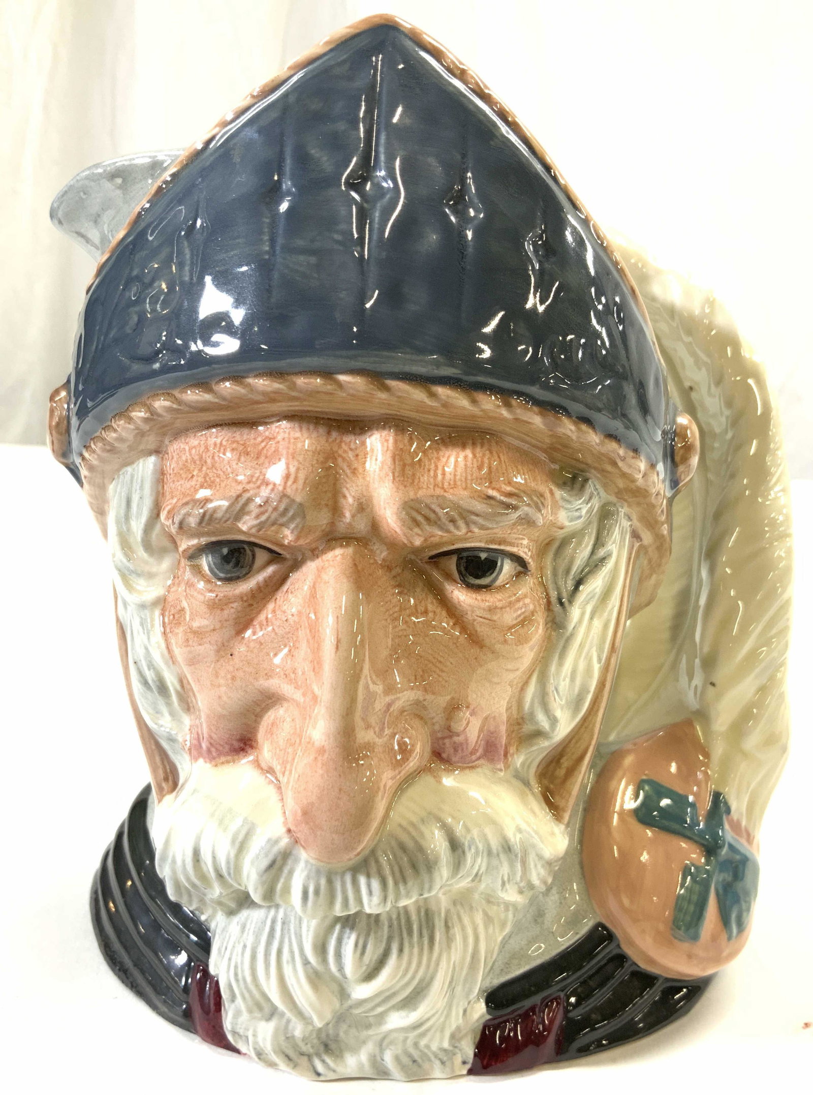ROYAL DOULTON DON QUIXOTE Porc Mug ENGLAND: Underside is marked ROYAL DOULTON DON QUIXOTE MADE IN ENGLAND. Mug appears to be vintage. Depicts an elderly male face figure in armor. Handle has feather shape. Piece measures approx 7.5 inches tall 