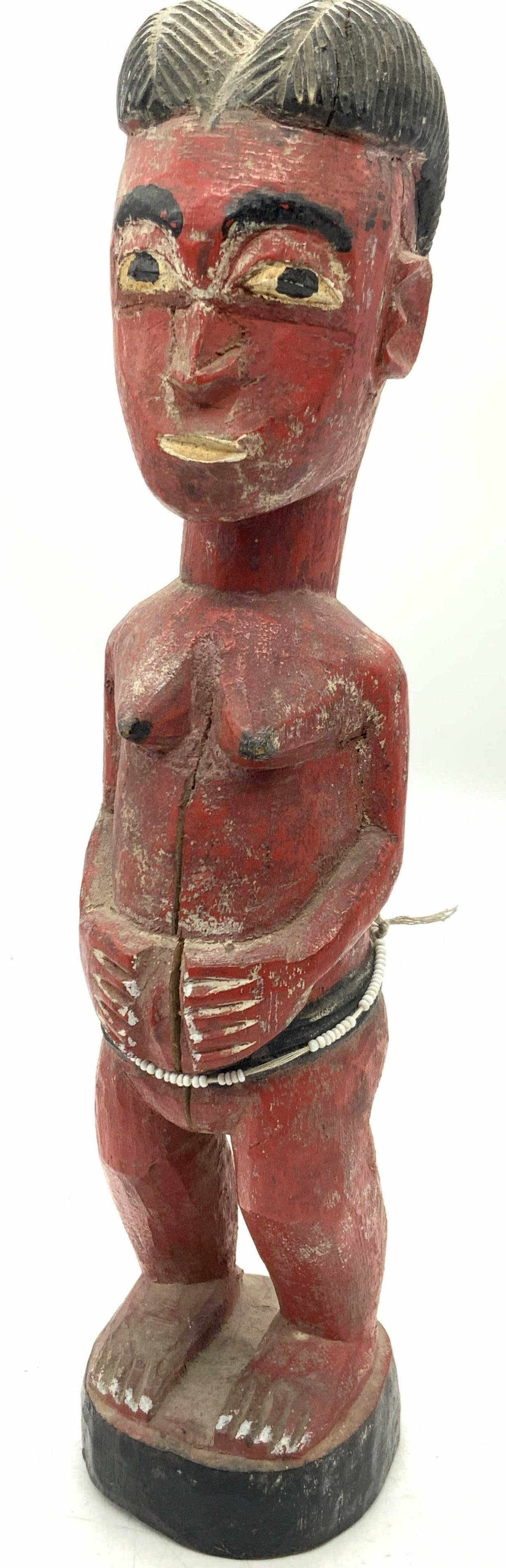 Vintage Wood African Baole Spirit Sculpture 1ftH: Vintage African Baole spirit sculpture, carved from wood. Depicting a nude female, painted red with hair bound. Depicted standing with hands in front of her and on black base. Approximately 12 inches