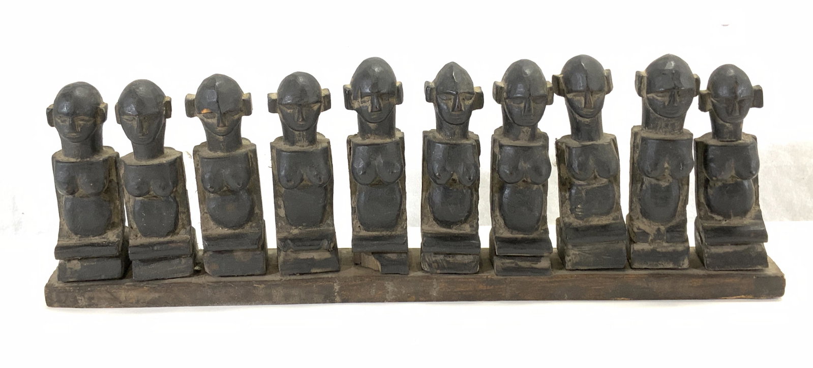 10 Antique Carved Wood Santal Puppets, Nepal: 10 antique carved wood Nepalese Santal Puppets mounted on wood. Total dimensions approx. 17 x 2 x 5.25 inches. Surface wear consistent with exposure. Property of Manhattan estate, Asian artifacts coll