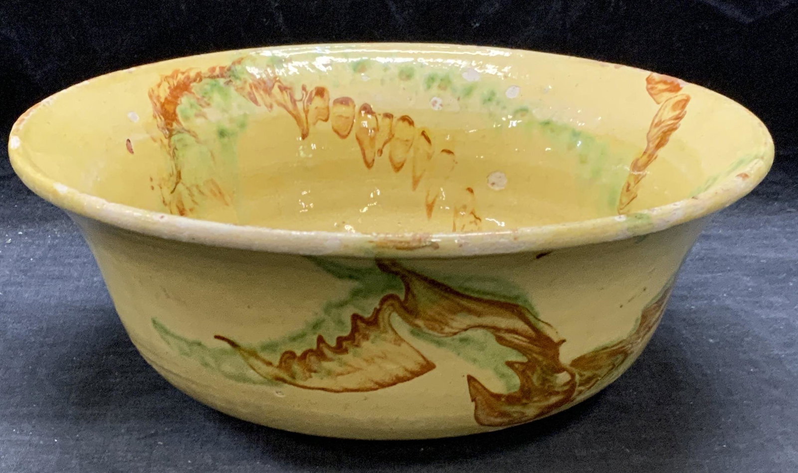 Vintage Yellow Art Pottery Bowl: Vintage, possibly antique, yellow toned art pottery bowl. Some chipping throughout observed. Measures approx. 10.25 inches diameter and 4 inches tall. Art pottery, art pottery bowl, ceramic bowl, yell