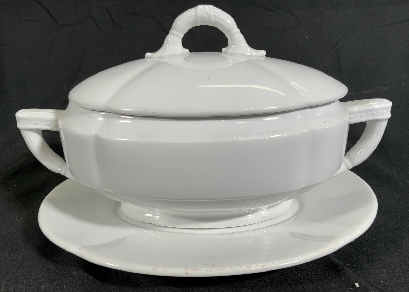 TC BROWN WESTHEAD MOORE &CO Porc Gravy Boat & Dish: Underside of dish reads TC BROWN WESTHEAD MOORE & CO. Each piece is white toned & Porcelain. Lot includes 1 gravy boat with handles & lid & 1 oval dish. Gravy boat measures approx 9 inches long 5 inch