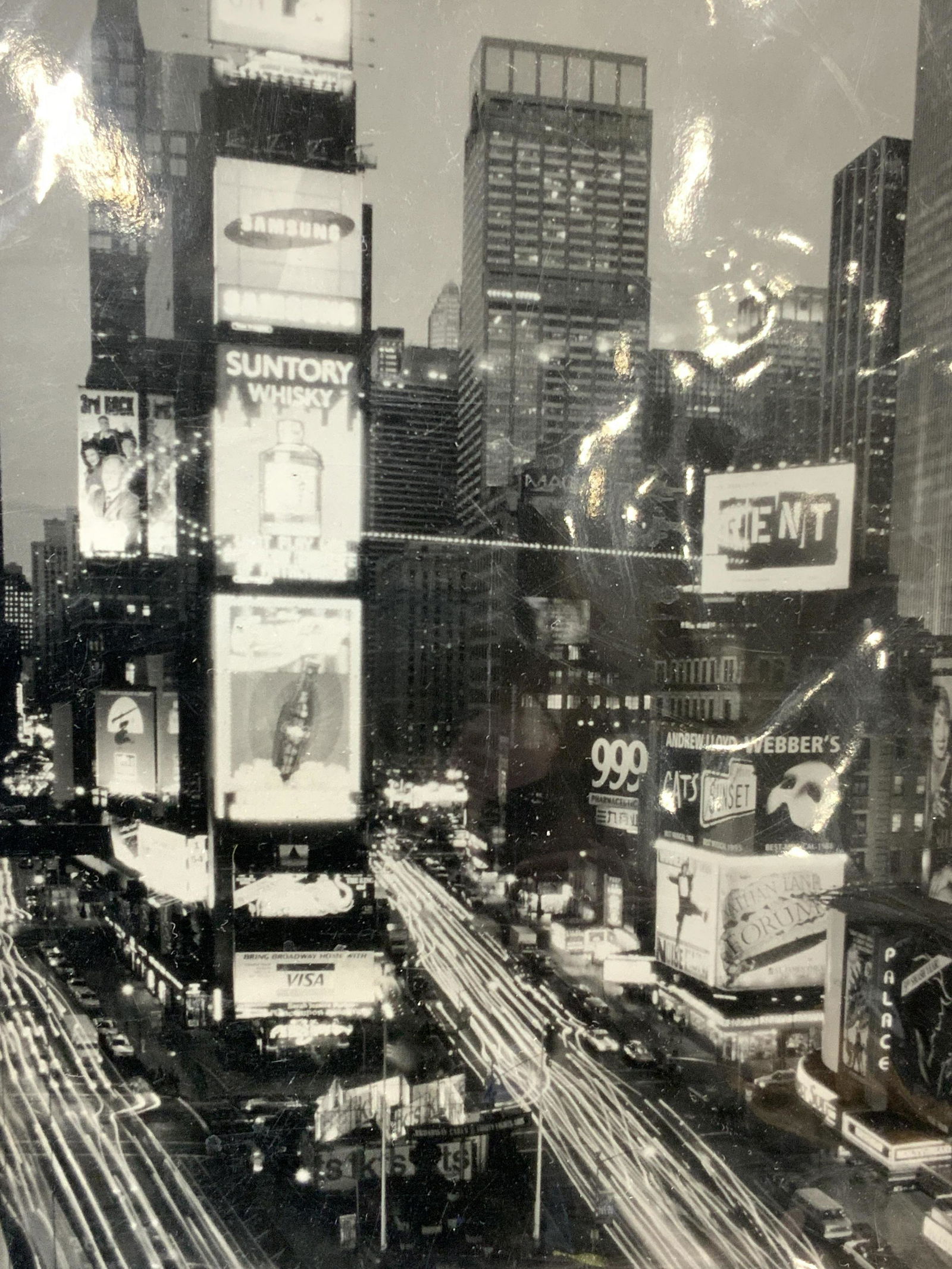 Black & White Time Square Photo Litho: Black and white photo litho Depicting a photo of a raised view of Times Square. Matted with black board. No frame Approximately 14 x 11 inches, window measures 7.25 x 5.25 inches Comes in plastic cove