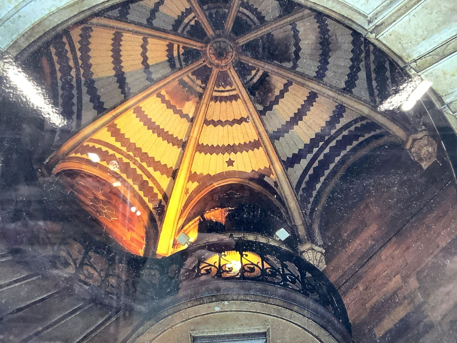 Stairs To The Belfry Notre Dame Photograph: Framed photograph looking up at the spiral stair case to the Beltry of the Basilique within Notre Dame, with a view of the domed roof. Framed within black wooden frame with white mat board. Approximat