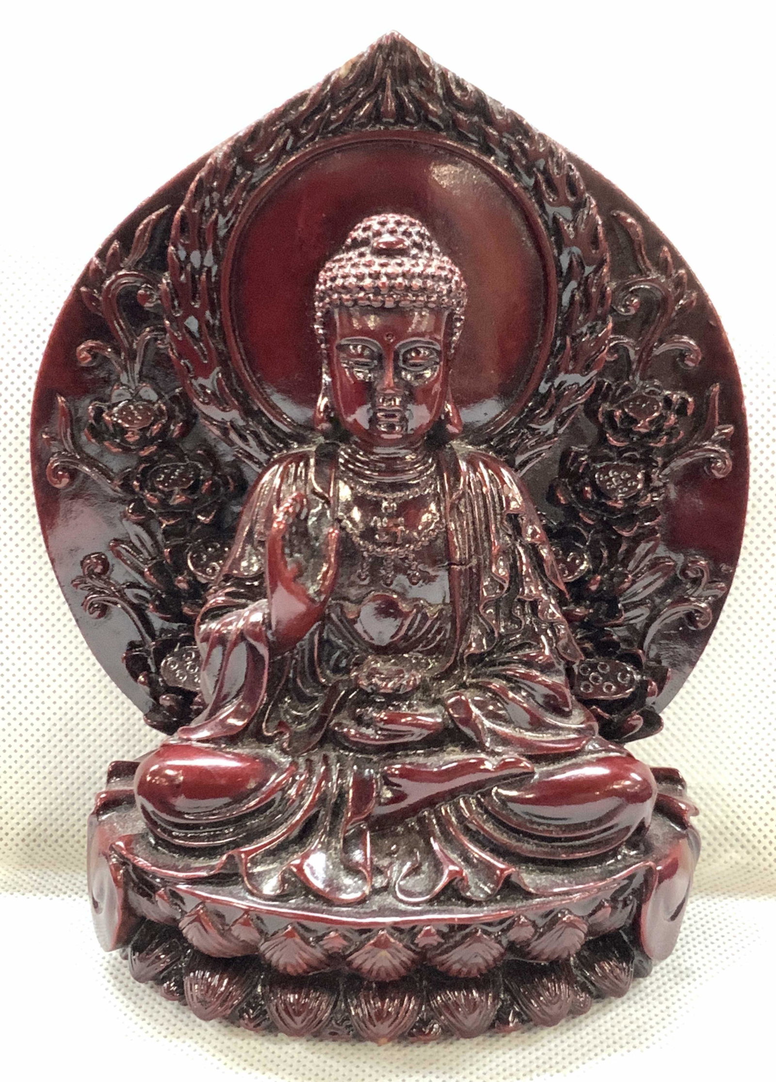 Carved Composite Buddha Figure: Lacquered composite carved figure of the Buddha seated upon a lotus with halo behind him. Seated in full lotus position with one hand holding a lotus flower at his waist and the other hand up and palm