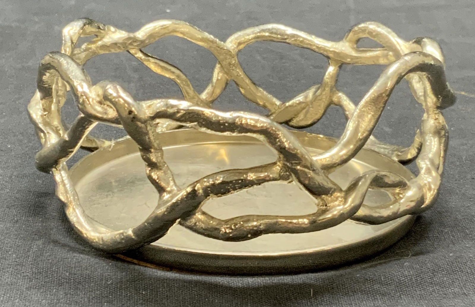 Michael Aram Silver Tn Wisteria Bottle Coaster: Michael Aram silver tone Wisteria wine bottle coaster. No label on piece. Measures approx. 4 5/8 x 2.25 inches. Some surface wear consistent with exposure. Michael arm, Michael Aram coaster, Michael A