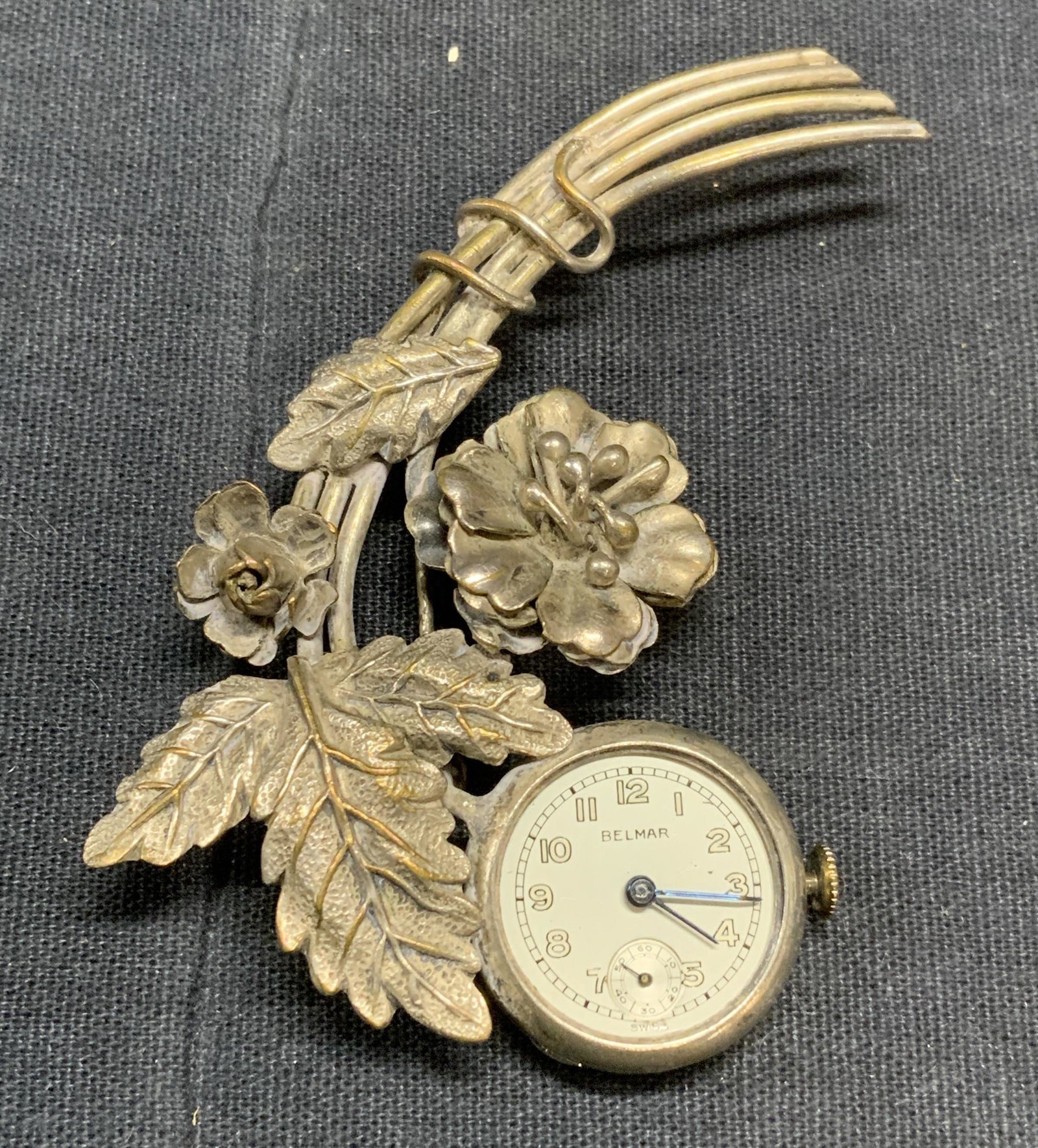 Vintage BELMAR Watch Pendant Brooch: Vintage Belmar silver tone watch pendant brooch with floral decoration. Watch not tested for function. Trademarked to watch face. Surface wear consistent with exposure. Loop for adding pendant to chai