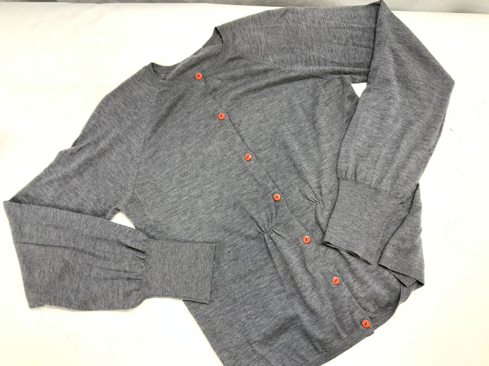 Grey Cashmere Cardigan w Orange Buttons: Size Medium Grey button down cardigan. Very Soft hand cashmere knitwear. 32 in. Waist. Long cuffs, crew neck with contrasting orange buttons. Label removed. Cashmere cardigan, Grey Cardigan Sweater, L