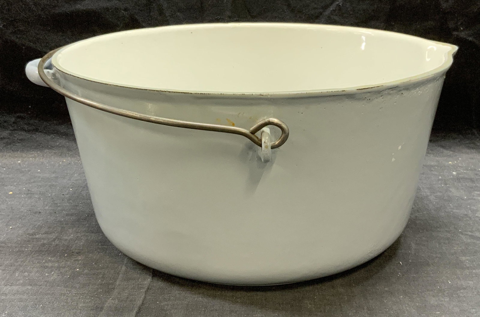Vintage Enameled Cast Iron Dutch Oven: Vintage enameled cast iron Dutch oven. Some surface wear consistent with exposure. Measures approx. 11.5 inches diameter and 5.75 inches tall. Piece is heavy. Dutch oven, kettle, enamel Dutch oven, ir