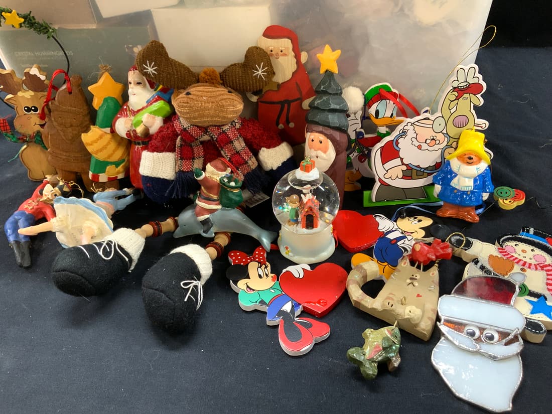 50 + Vintage Wooden & Modern Christmas Ornaments: Group lot of 50+ vintage Christ ornaments, wooden and modern displaying images of carved Santas, ceramic ornaments of Santa and toy soldiers, wooden reindeer and snowmen and wooden Disney ornaments of