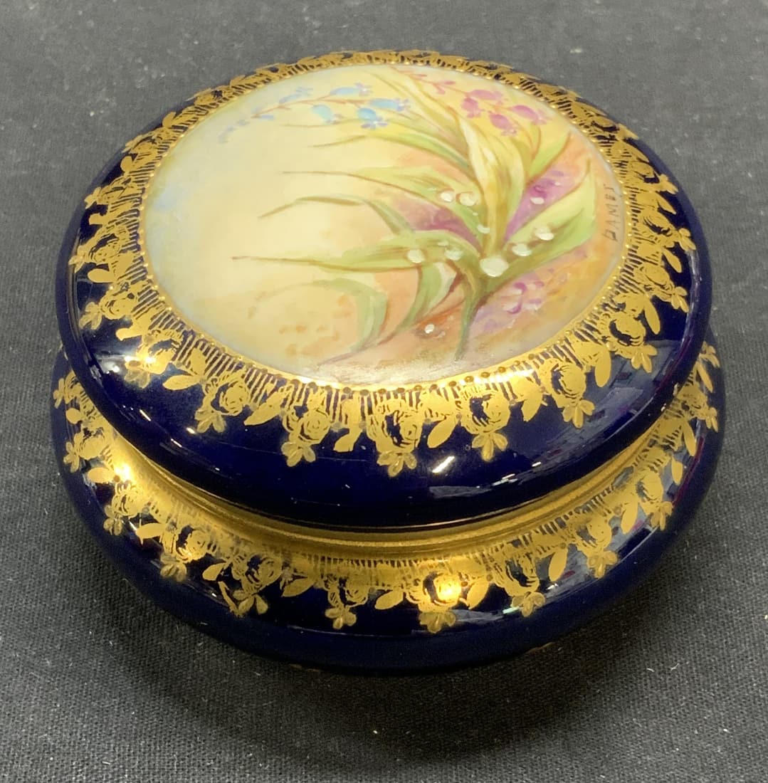P Thabard Limoges Porcel Cobalt Trinket Box France: P. Thabard Limoges cobalt blue porcelain trinket box with hand painted floral motif and gilt decoration. Trademarked to underside. Some surface wear consistent with exposure. Measures approx. 3.5 x 2.