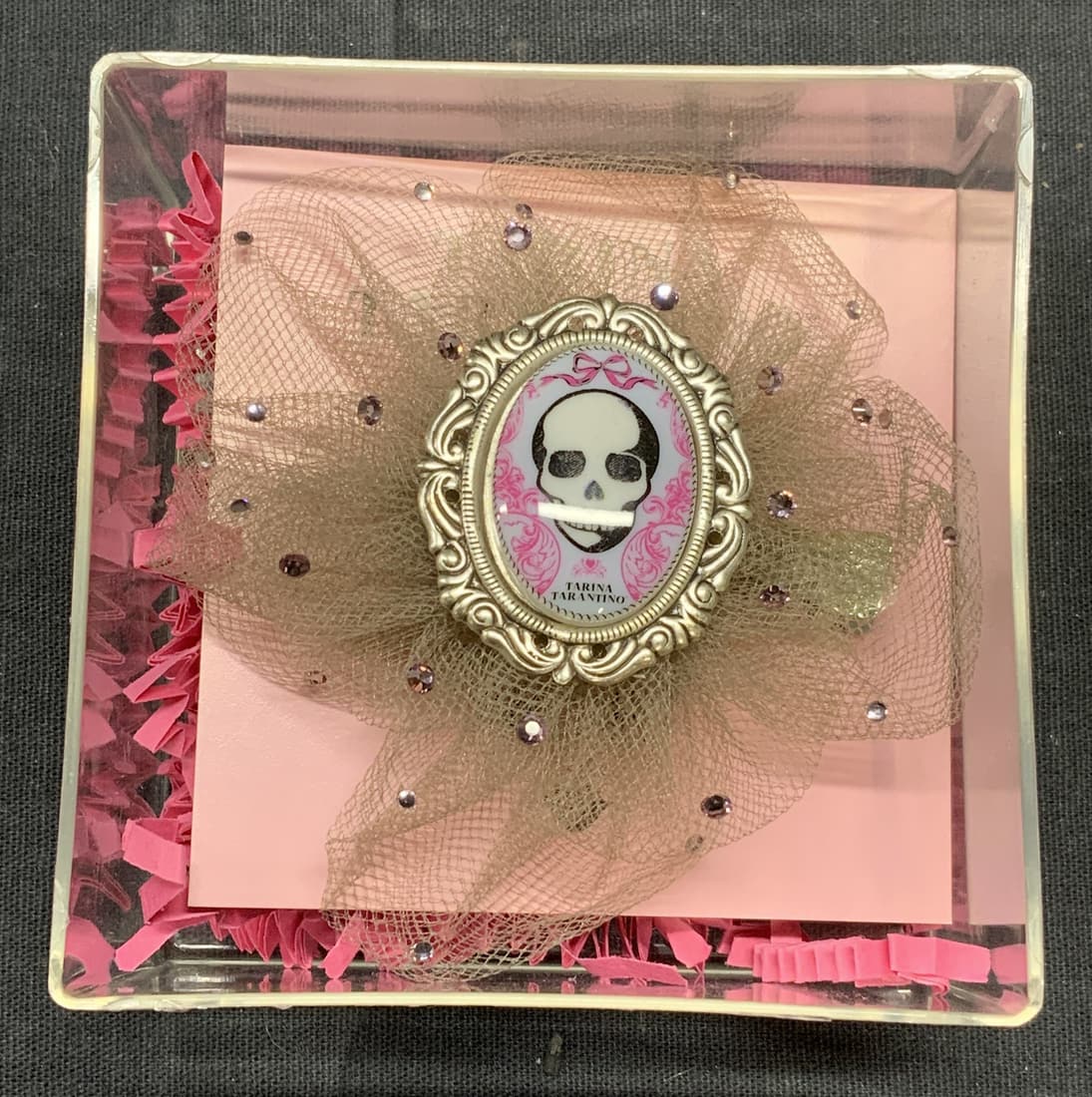TARINA TARANTINO Skull Hair Clip: TARINA Tarantino skull hair clip. Designer label to back of clip. Fabric, metal, lactic, and crystallized Swarovski elements. Measures approx. 3 inches diameter. New with tag. TARINA Tarantino, TARINA