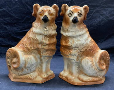 Pair Vtg Staffordshire Style Spaniel Dog Figurals: Pair of vintage, possibly antique, Staffordshire style ceramic spaniel dog Figurals. Pieces are unmarked. Hues of orange and white with gilt decoration. 1 piece has orange Cabochon decorated eyes. Bot