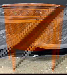 Vntg Inlaid Wooden Demilune Cabinet: Cabinet is vintage. Piece is wooden with intricate inlaid marquetry detail. Demilune has cabinet & drawer. Drawer has gold toned metal knobs. Demilune measures approx 33.25 inches tall 35 inches inche