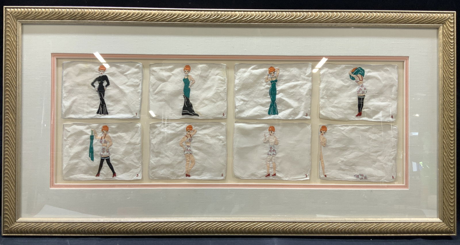Framed Vintage Applique Linens Napkins: Framed set of 8 pictorial linen napkins with images of a red headed woman undressing from a black gown. Each napkin is numbered in sequence of 1-8 in corners. Floater framed in leafed wooden frame wit