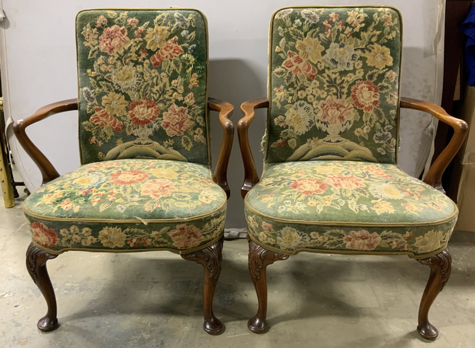 Pair Antique Carved Wooden Queen Anne End Chairs: Appears to be antique possibly vintage. Lot includes 2 end chairs. Each have carved wooden frames with Queen Anne legs and wooden arms. Some edges of upholstery have double welting. Chairs are upholst