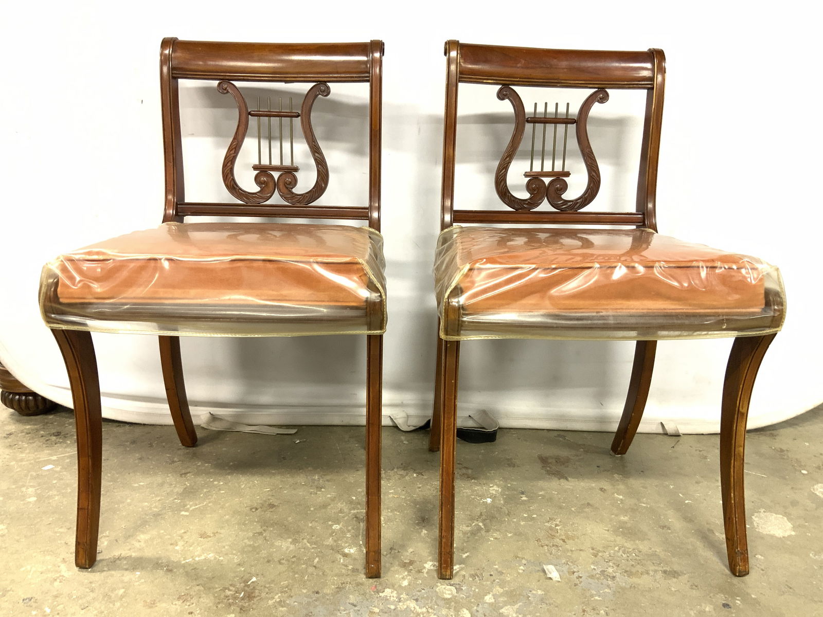 Pr Vintage Carved Wooden Lyre Back Chairs: Chairs are each vintage & wooden. Each has lyre backrest. Chairs each have orange toned upholstered seats with welting. Each chair measures approx 34 inches tall 19 inches wide 21 inches deep. Chairs,