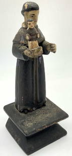 Antique Wooden Saint Anthony Santos Doll: Antique wooden santo doll depicting Saint Anthony holding a baby on top of the Bible in one of his hands. Figure is affixed to black wooden base. Approximately 8.25 inches tall and base is approximate