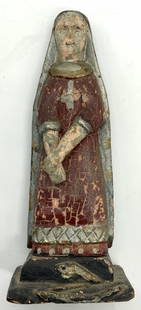 Antique Painted Wooden Virgin Mary Figure: Antique wooden Figure depicted as The Virgin Mary, with red robes and blue head scarf that goes down to her feet with hands crossed in front of her and a cross painted on her chest. Approximately 8.25