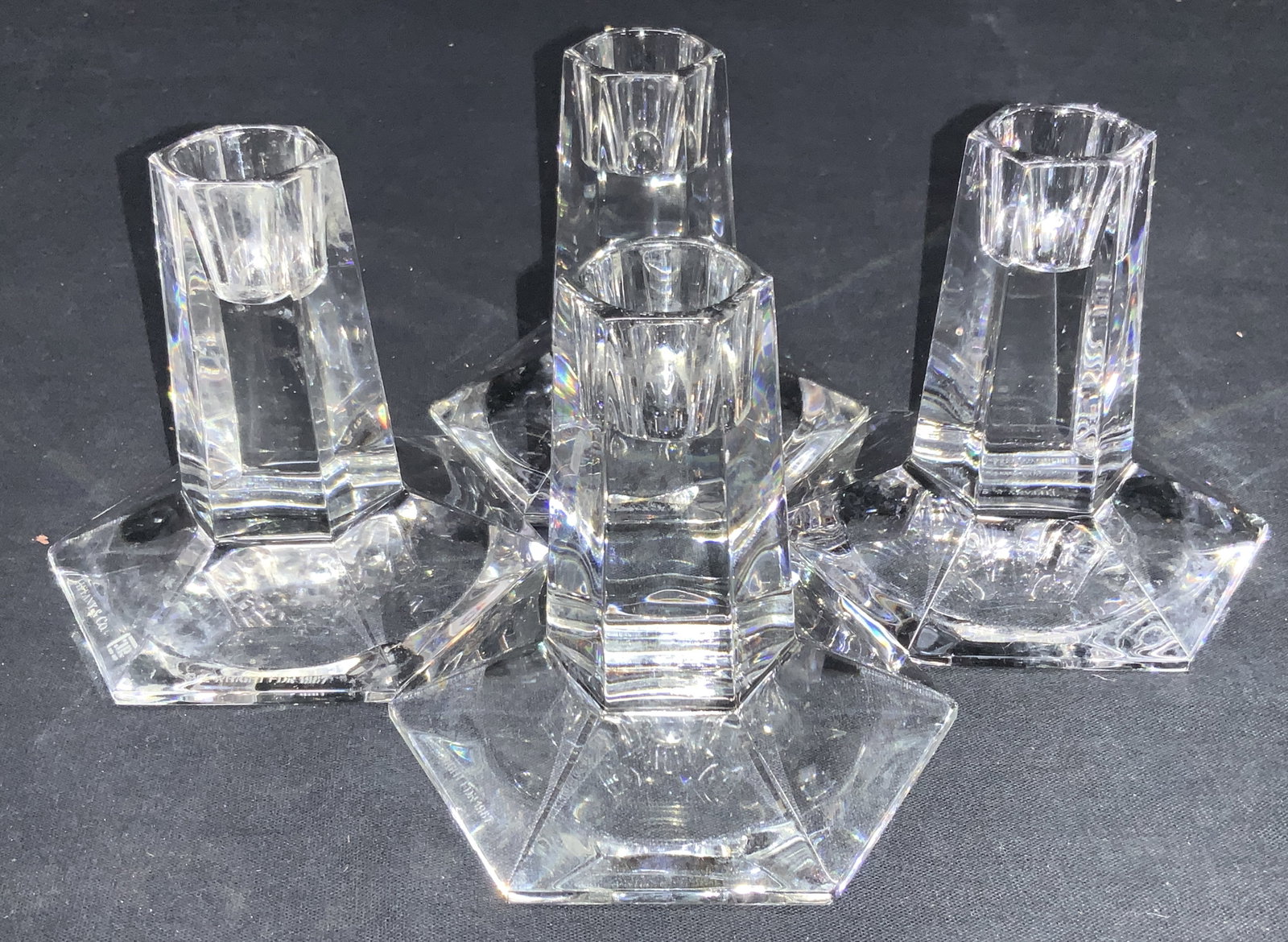 Set 4 Tiffany & Co Faceted Crystal Candle Holders: Set of 4 faceted crystal candle holders in a hexagonal shape. Marked on underside Tiffany & Col FL Wright 1987 Approximately 4 inches tall. Minor surface wearing. Tiffany & Co crystal, crystal candle 