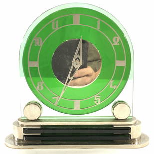 Art Deco Cyma Watch Co Glass&Brass Clock, Swiss: Art deco vintage wind up/ mechanical clock. Heavy piece, Blue- green tempered glass with a round green glass juxtaposed in front. Silver tone over brass base with brushed metal numbers. Hallmarked Cym