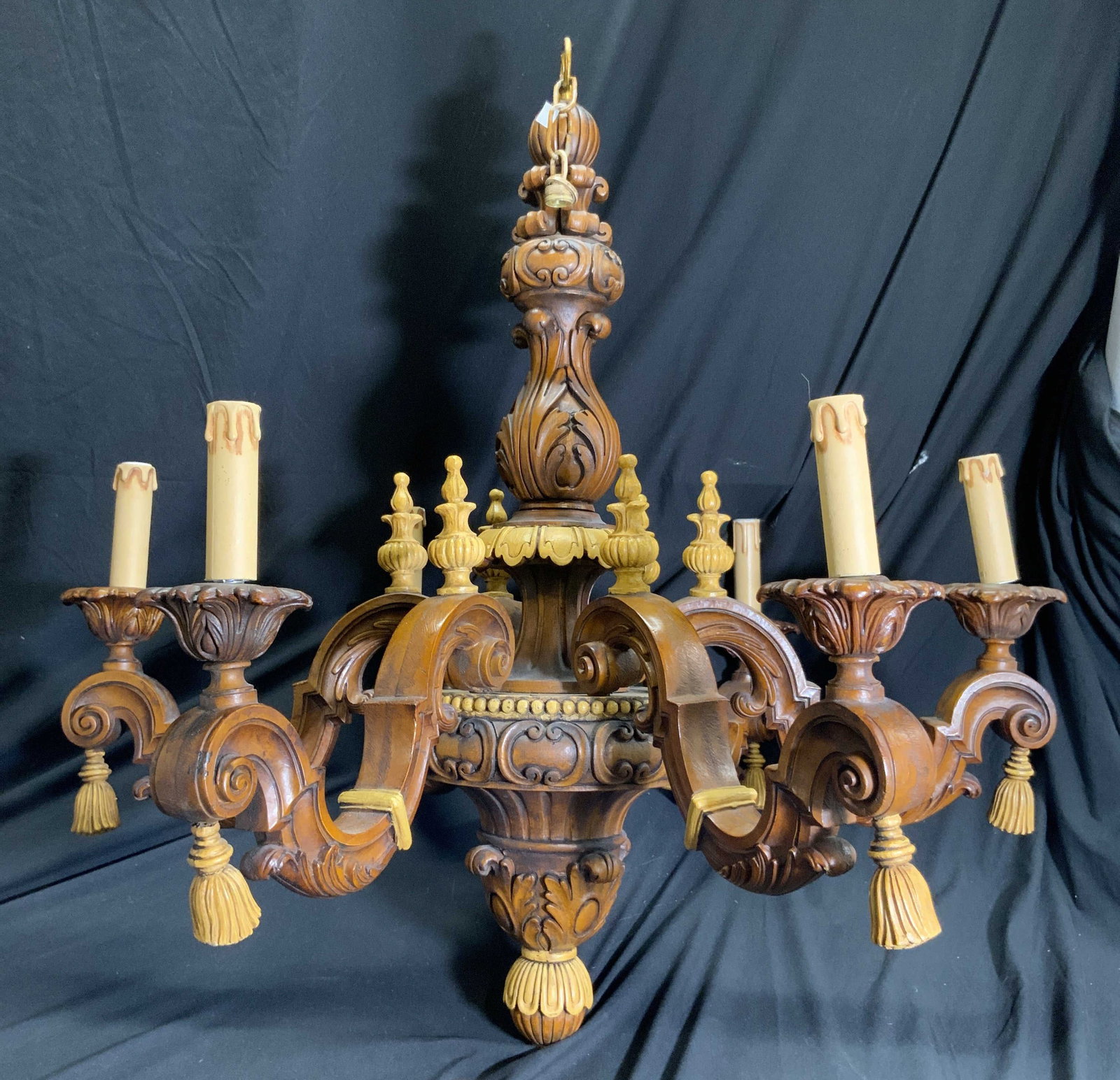 19th Century Louis XVI Wooden 6 Arm Chandelier: Chandelier is vintage and wooden. Piece is 19th century Louis XVI style. Chandelier has 6 arms with carved curl detail. Piece has other carved areas with C curve, leaf, & tassel skirt detail. Ends of 