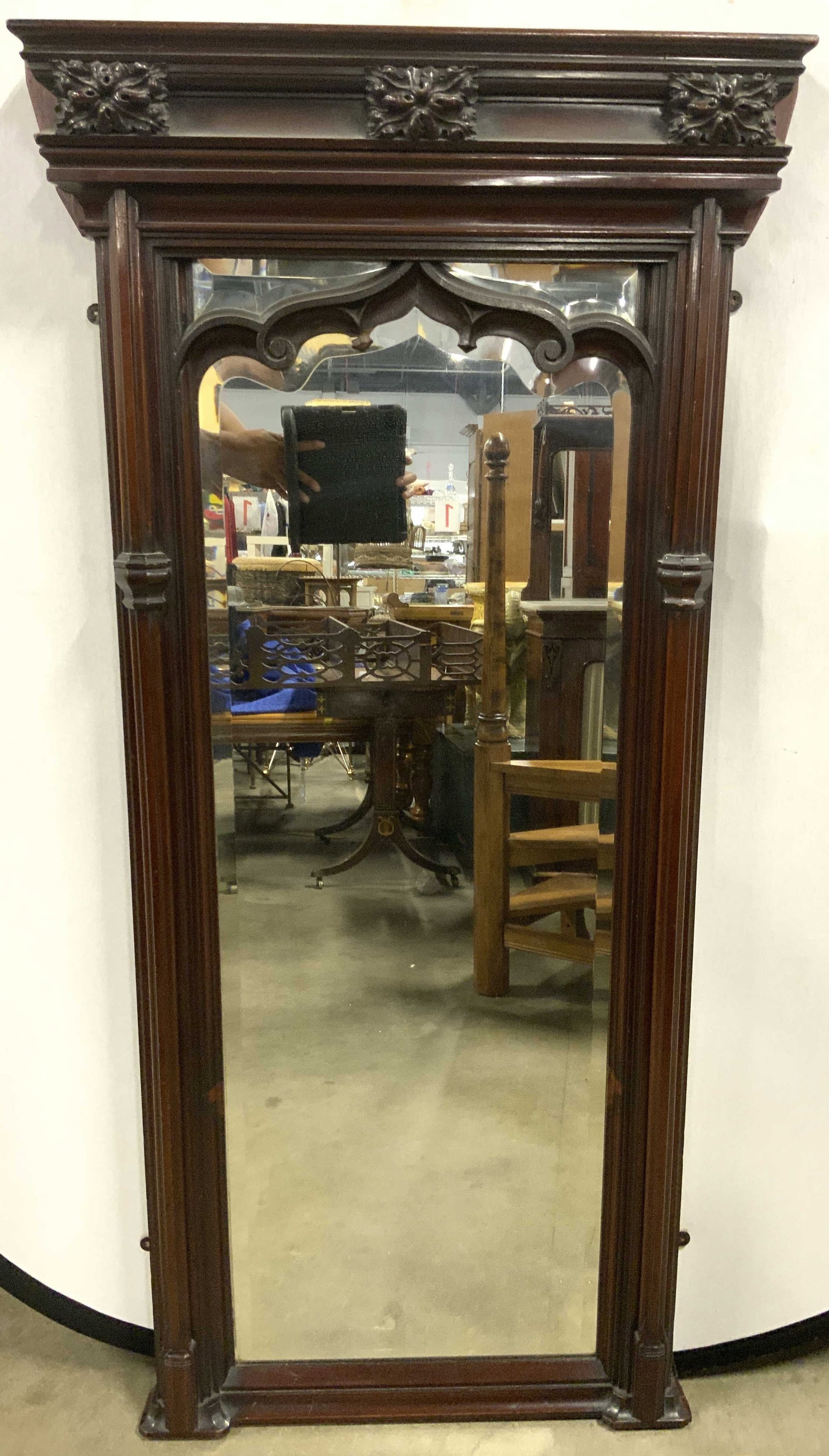 W F CLOKEY & CO Vntg Beveled Mahogany Mirror: Tag on top of piece reads W F CLOKEY & CO. Mirror is heavily weighted, appears to possibly be mahogany. Mirror has beveled surface. Piece has intricately carved detail. Measures approx 56 inches tall 