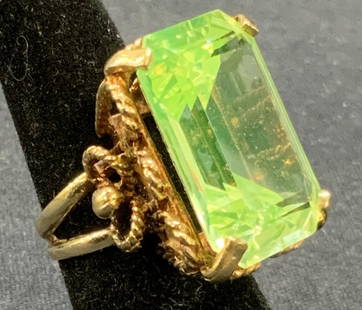 14k Gold & Peridot Emerald Cut Statement Ring: 14k gold and peridot statement ring. Emerald cut bright green peridot gemstone. Marked 14k to interior band. Some surface wear consistent with exposure. Ring size 6. Peridot measures approx. 1 x .75 i