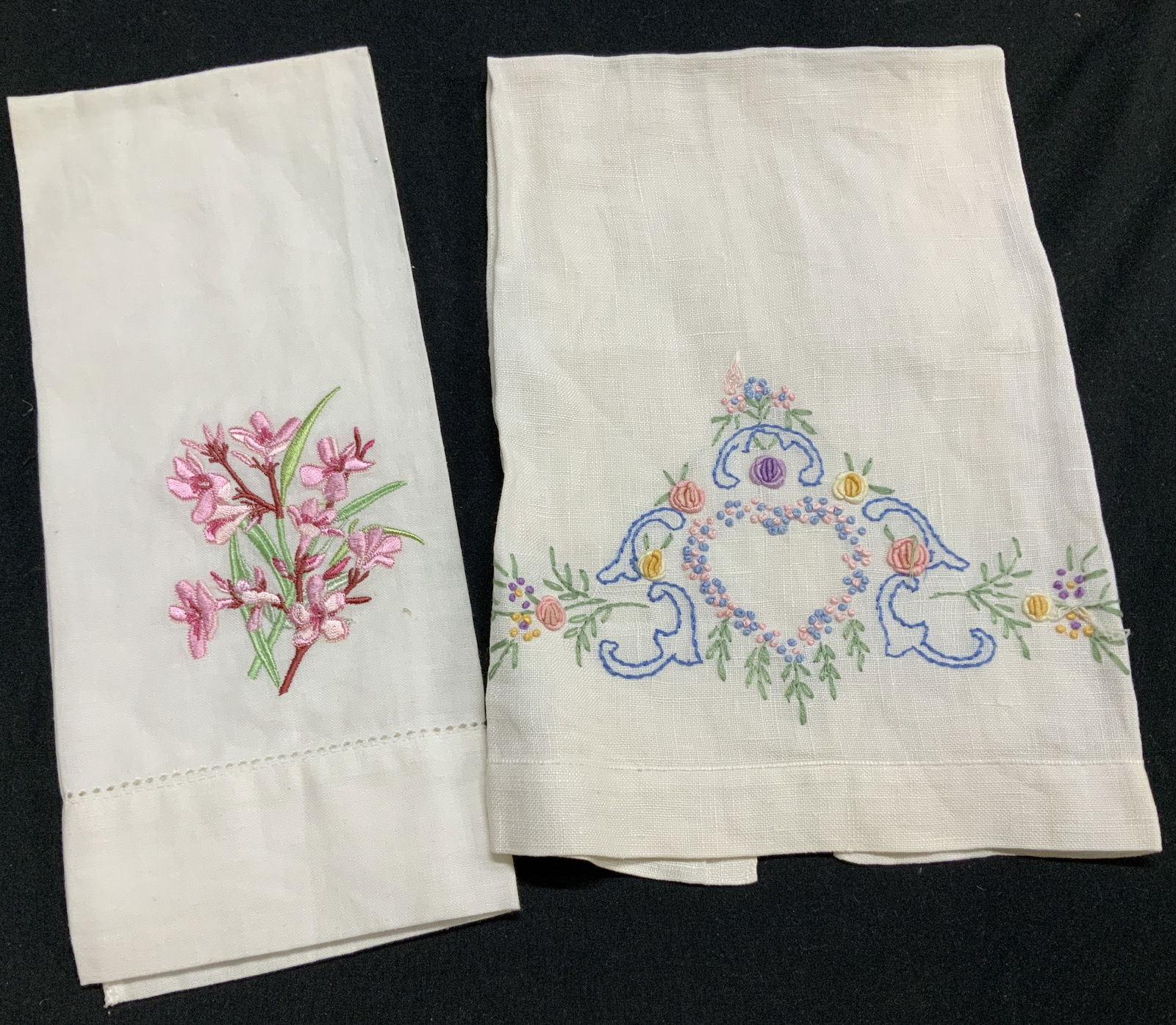 Pair White Embroidered Linen Hand Towels: White linen and cotton hand towels, one hand embroidered, the other machine embroidered with label ‘The Carol Holding Shop, Bermuda , 21 3/4 x 13.25 in. and 20 x 15 in. Powder room hand towels, line