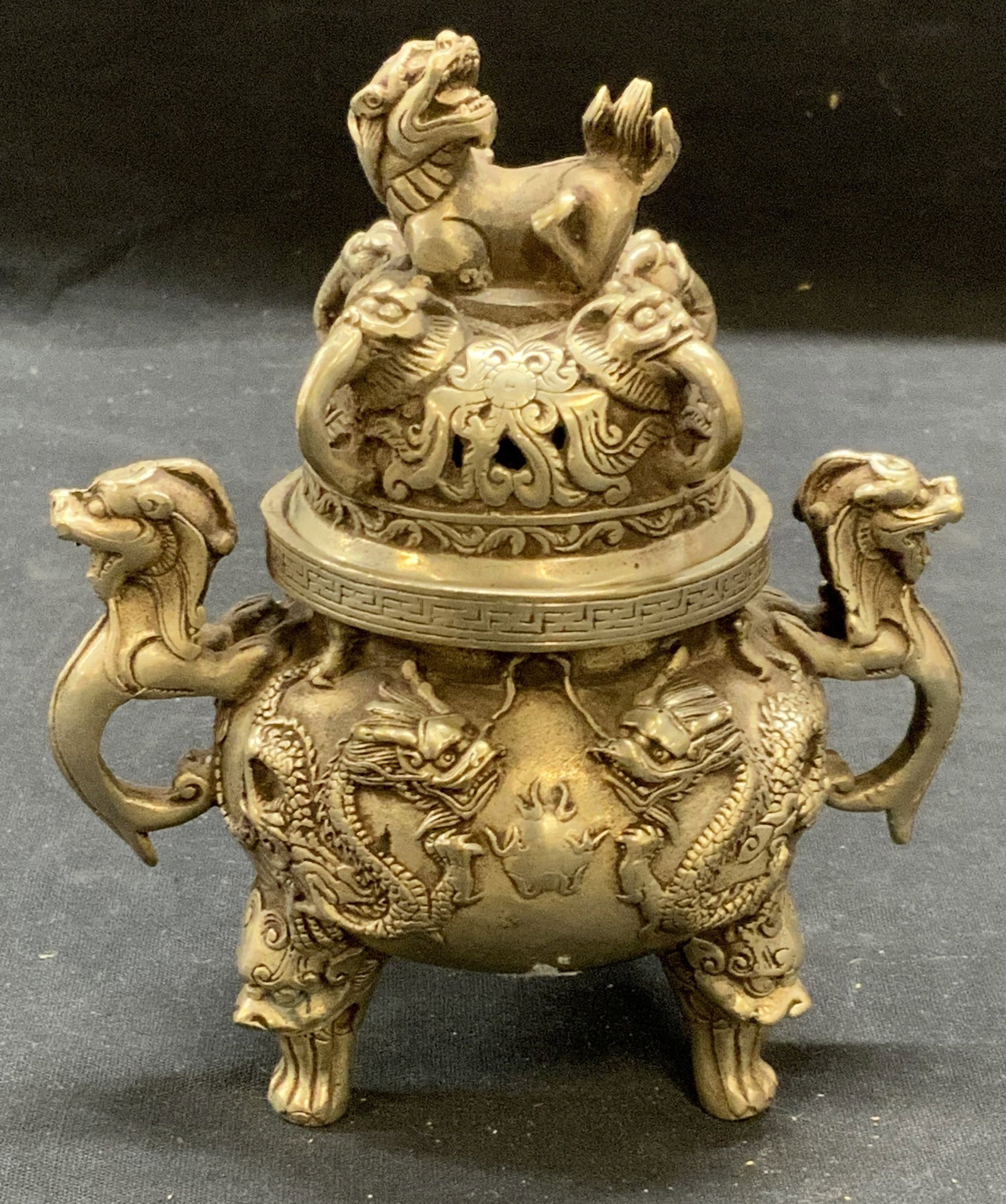 Stamped Chinese Pewter Incense Burner: Stamped Chinese pewter incense burner with foo dog and dragon motif. Stamped to underside. Some surface wear consistent with exposure. Measures approx. 4.5 x 5.25 inches. Chinese incense burner, Asian