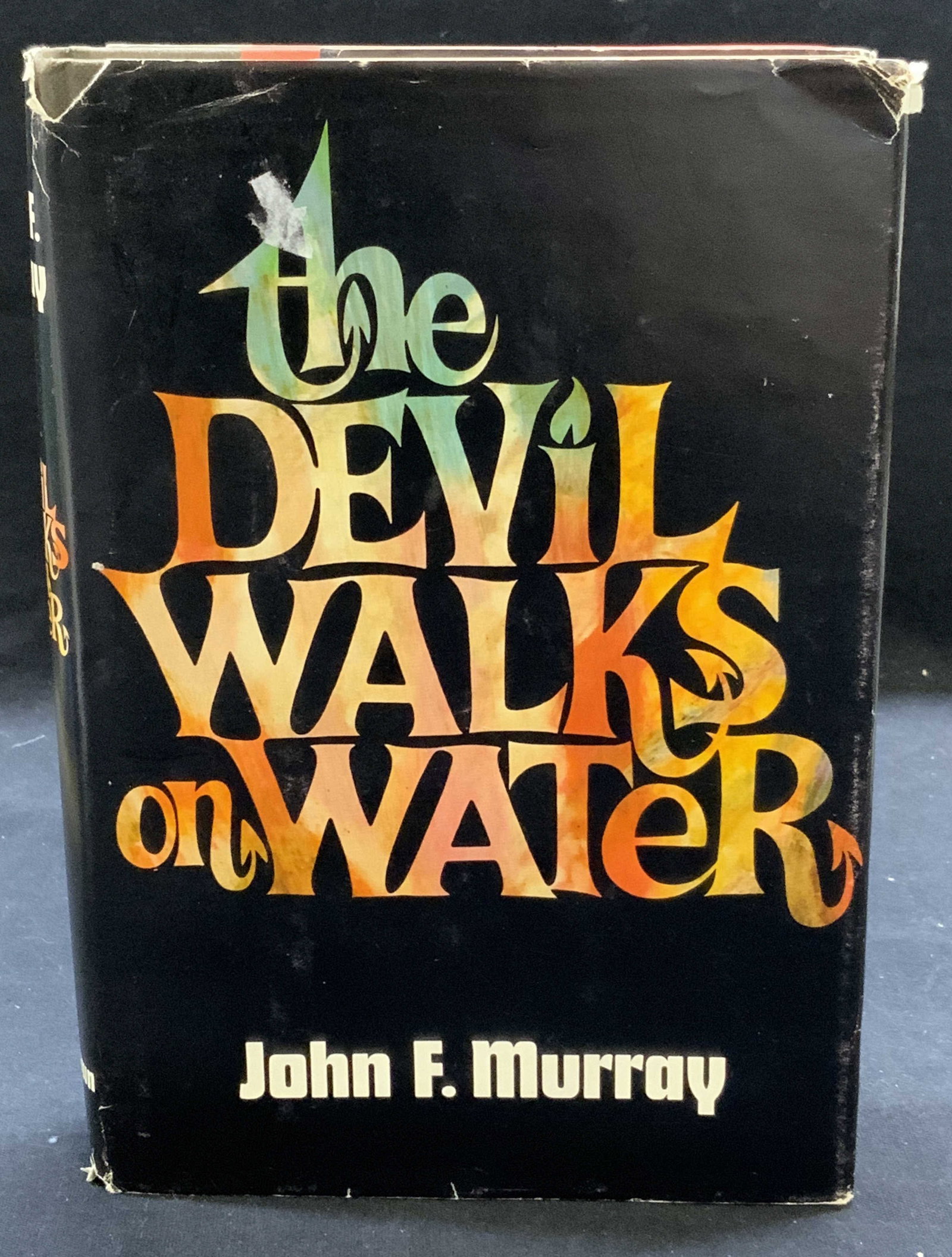 Signed John F Murray Devil Walks on Water: Hardcover copy of The Devil Walks On Water by John F Murray. Signed by author on flyleaf. Published by Little, Brown & Co, 1969. Wear to cover, pages, and spine consistent with exposure. Measures appr
