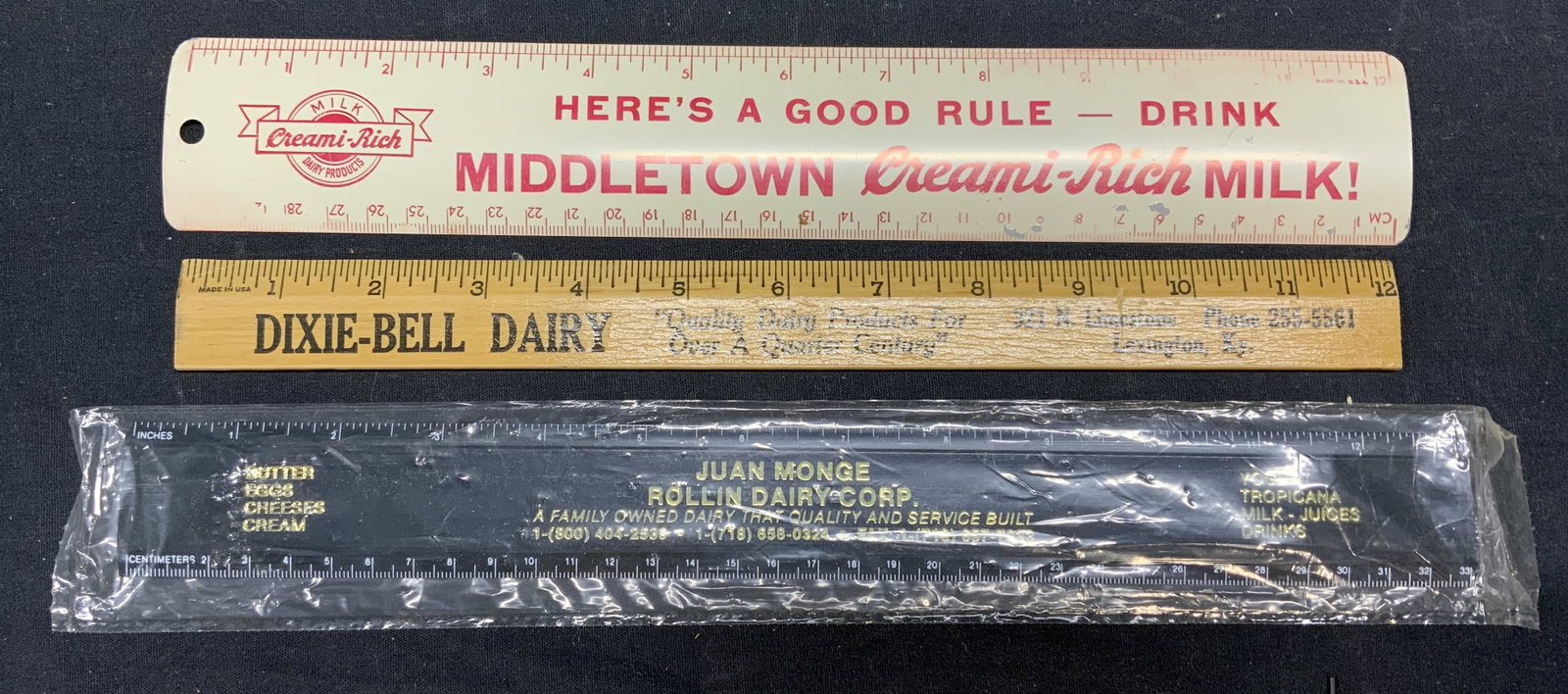 Lot 3 Vintage Dairy Company Rulers: Lot of 3 vintage Dairy Company promotional rulers, wood, metal and plastic. Middletown Creami-Rich Milk, Dixie-Bell Dairy, Juan Monge Rollin Dairy Corp. longest ruler 13 inches. All pieces have some s