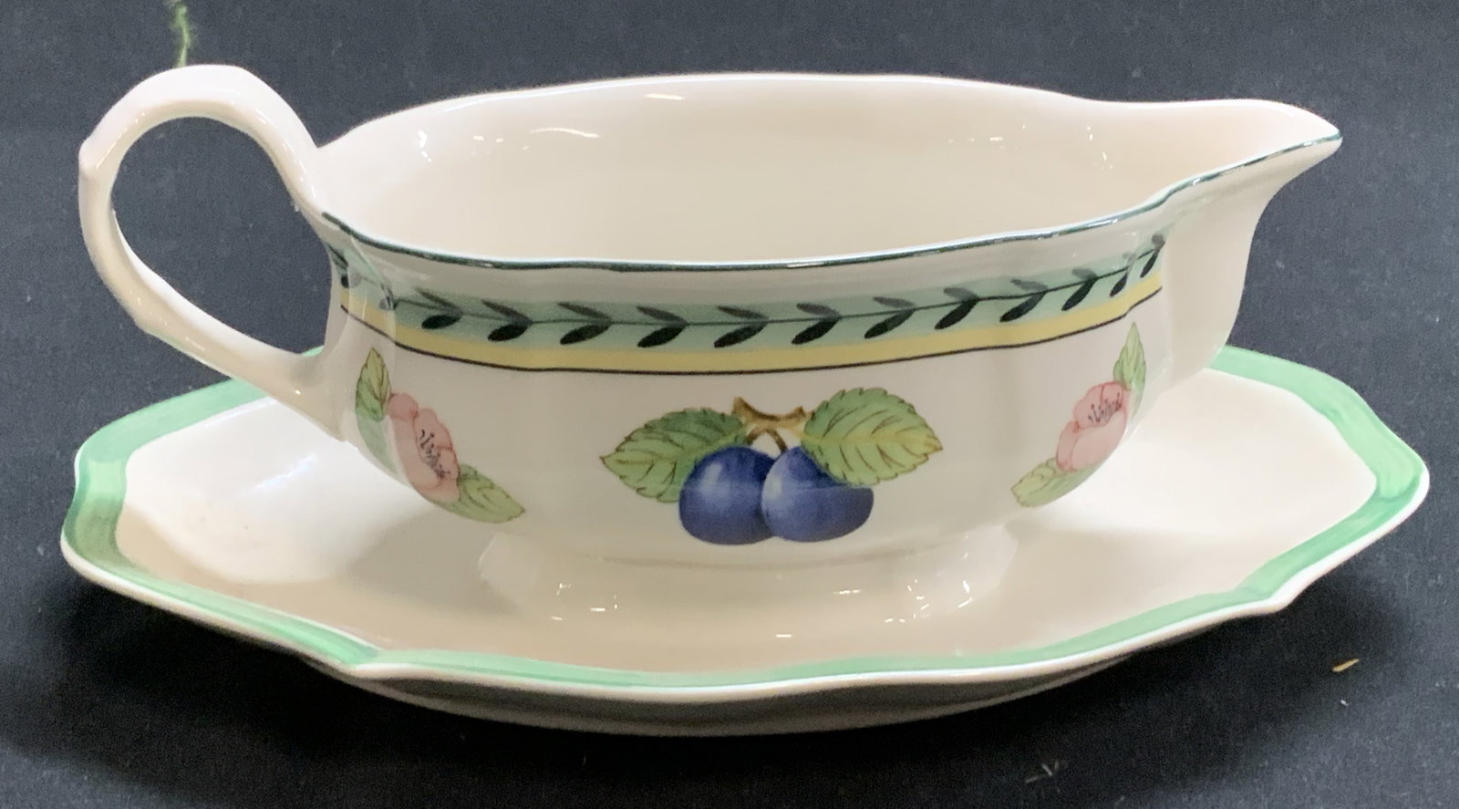 Villeroy & Boch Porcelain Gravy Boat, Germany: Villeroy & Boch fruit Motif porcelain gravy boat with attached under plate. Made in Germany. Measures 8.25 x 6 x 3.5 in. Ht. Villeroy & Boch Fruit Gravy Boat, Villeroy & Boch porcelain ware, Villeroy 