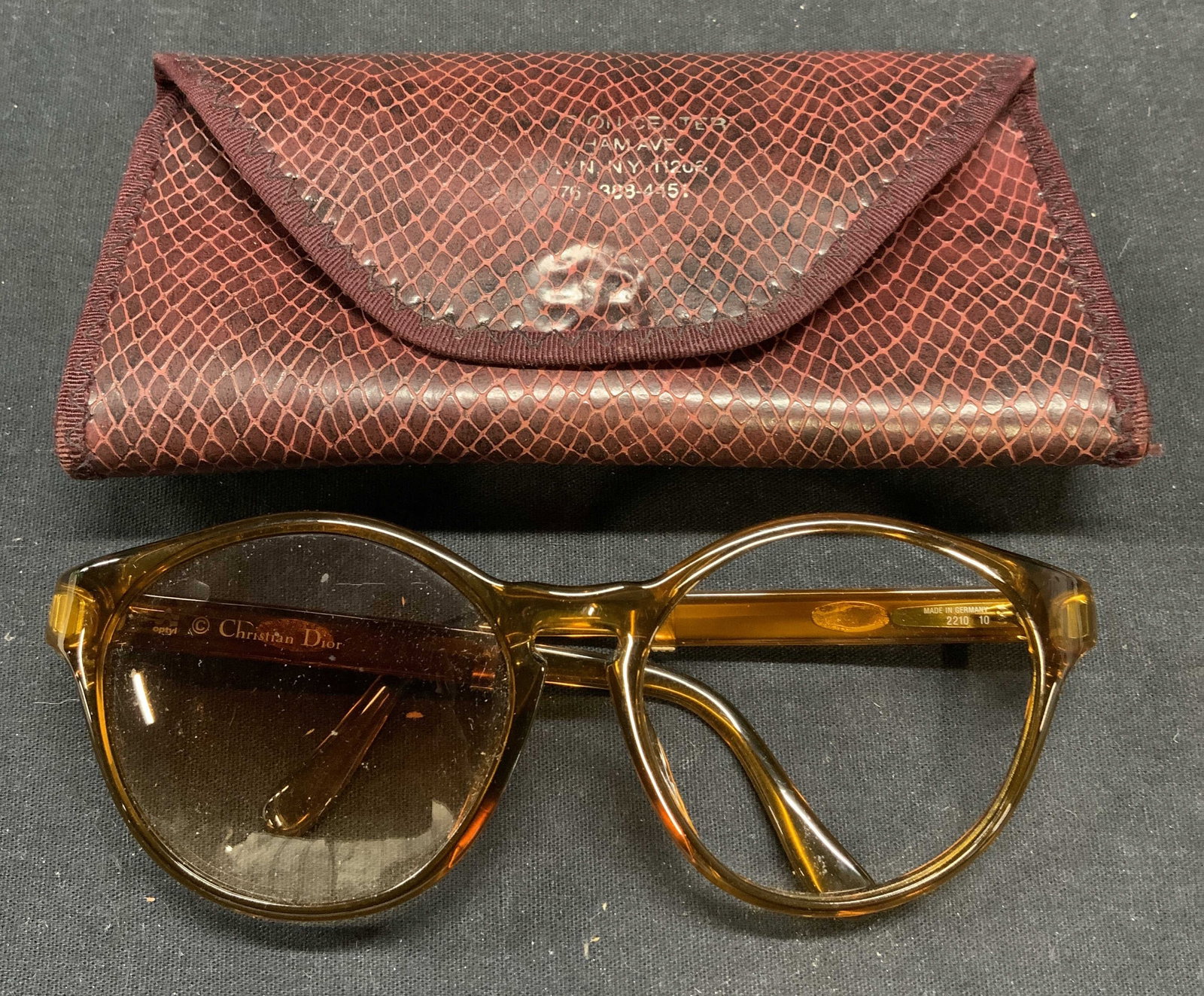 Christian Dior Amber Round Sunglasses: Christian Dior amber acrylic round frame sunglasses and case. Designer label on arm. Surface wear consistent with exposure. Measure approx. 5 x 5.5 x 2.25 inches. Christian Dior, Christian Dior sungla