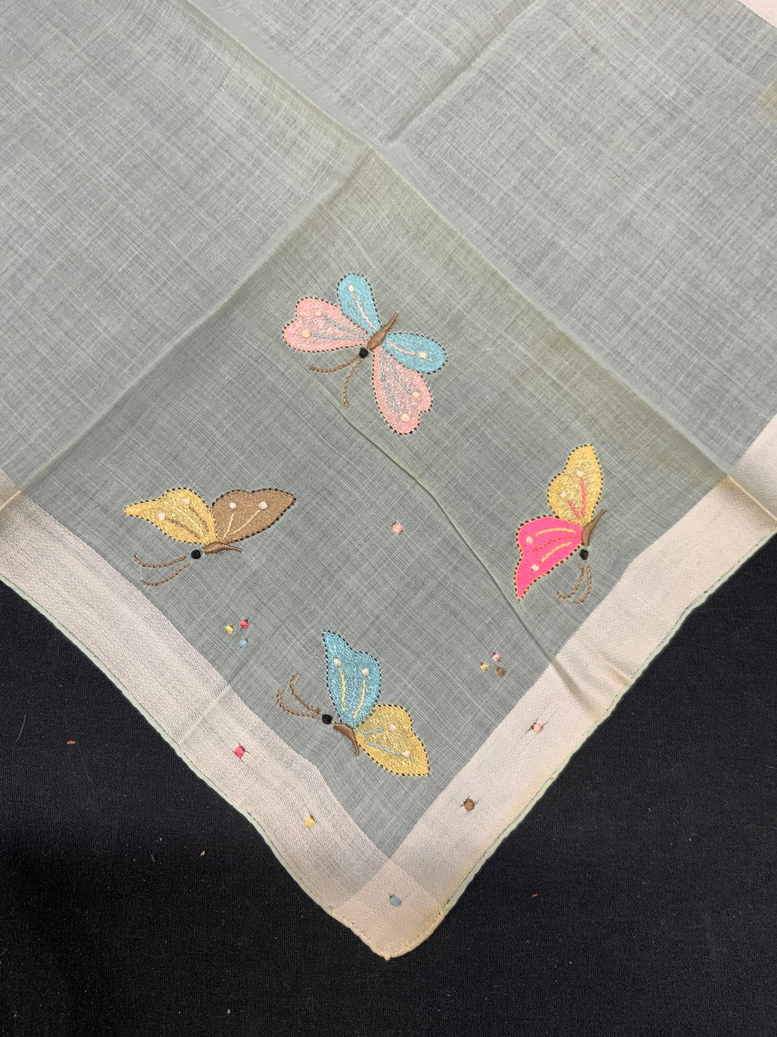 Embroidered Cotton Butterfly Handkerchief: Blue and white embroidered cotton handkerchief with butterfly motif. Wear to material consistent with exposure. Measures approx. 14 x 14 inches. Butterfly handkerchief, blue handkerchief, embroidered 
