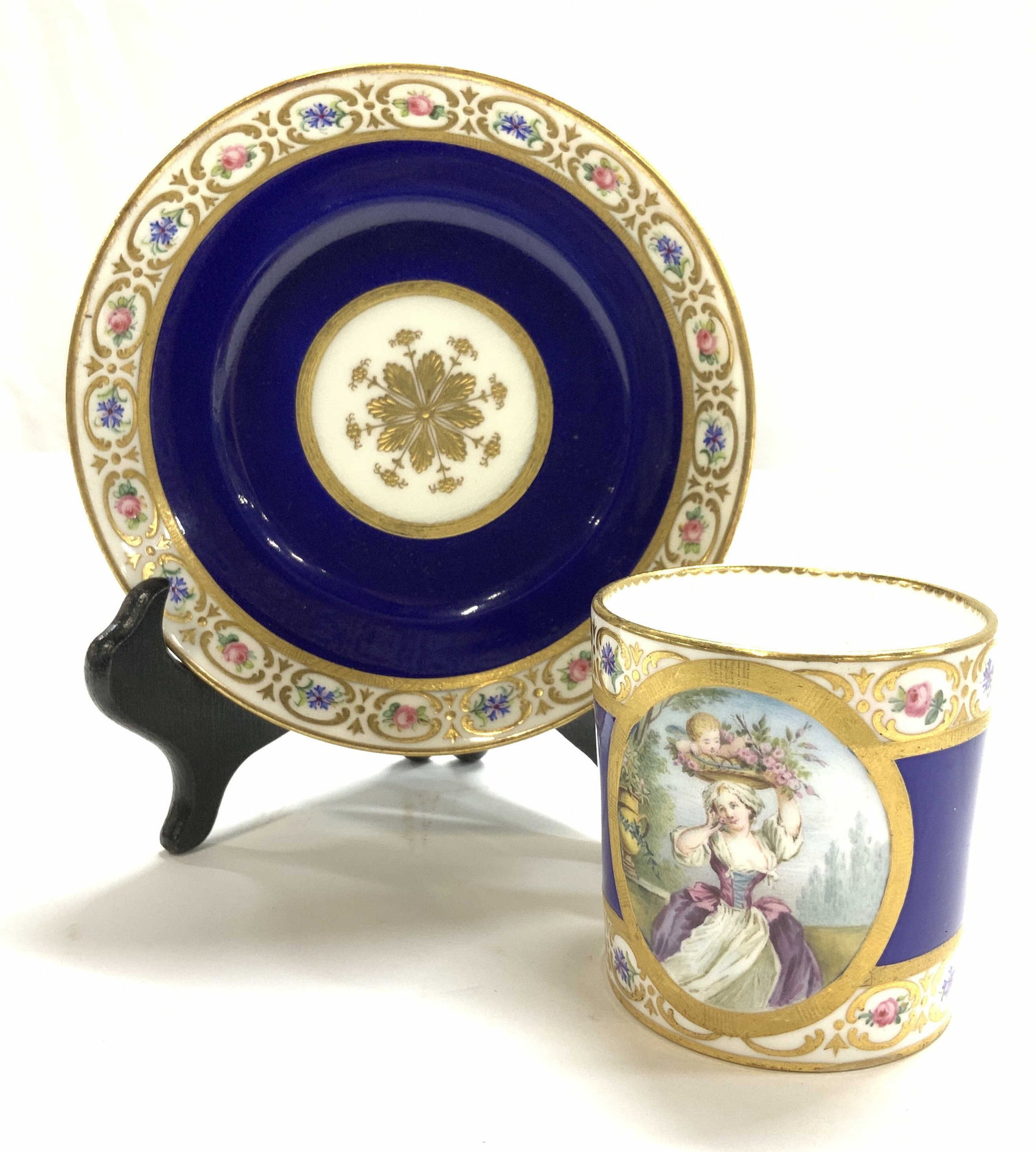 MINTONS Antique Demitasse Cup & Saucer, England: 19th Century -early 20th Century Mintons Hand painted Demitasse chip and saucer / bowl. c1891 to 1912. White porcelain painted cobalt blue and 24 k gilt , accented with flowers. Cup has image of a Vic