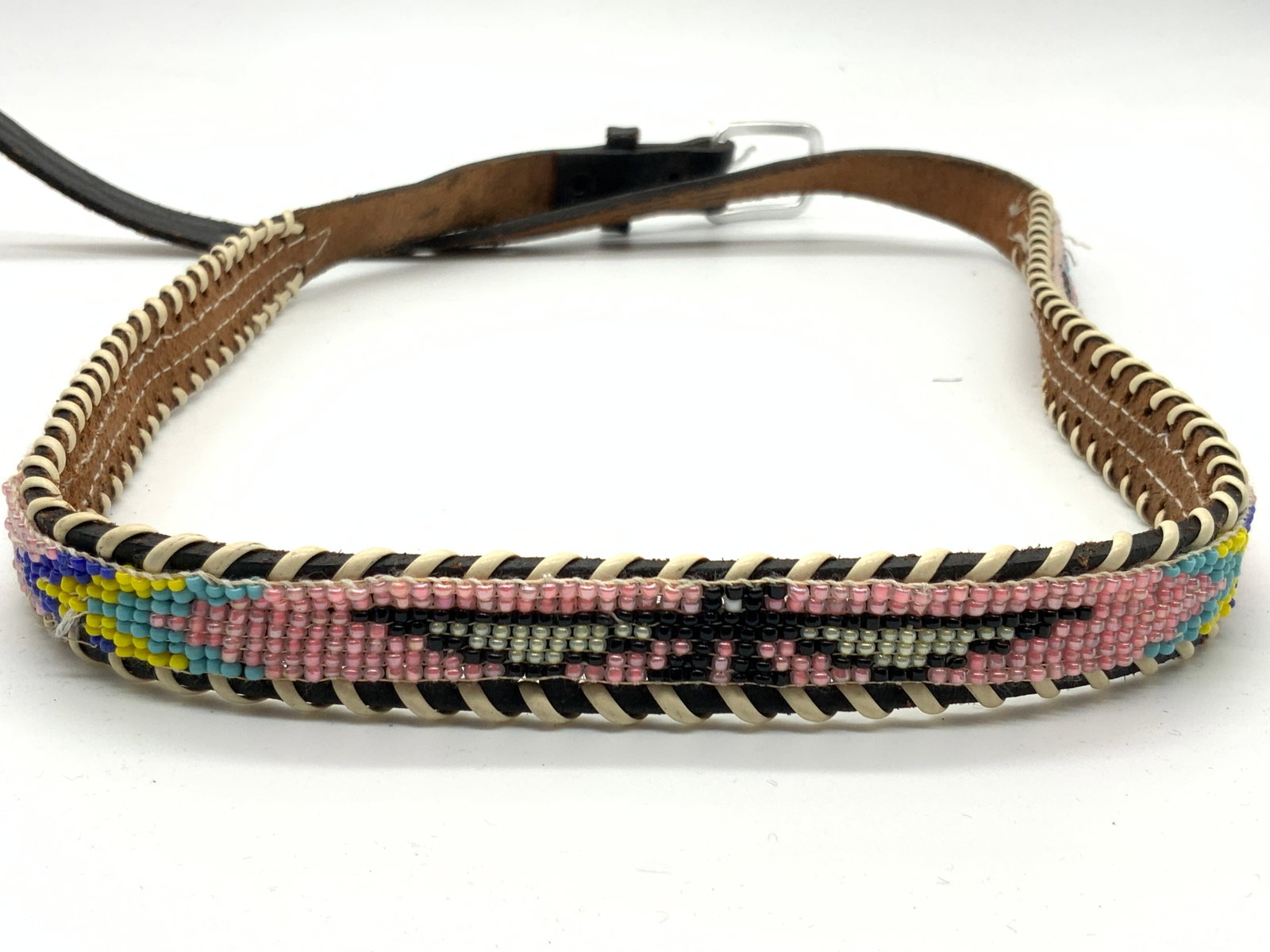 Native American Style Seed Bead & Leather Belt: Vintage leather made fashion belt with woven seed bead designs in pink, blues and yellows with Native American style designs and patterns. Approximately 38 inches long Evident wearing to leather and l